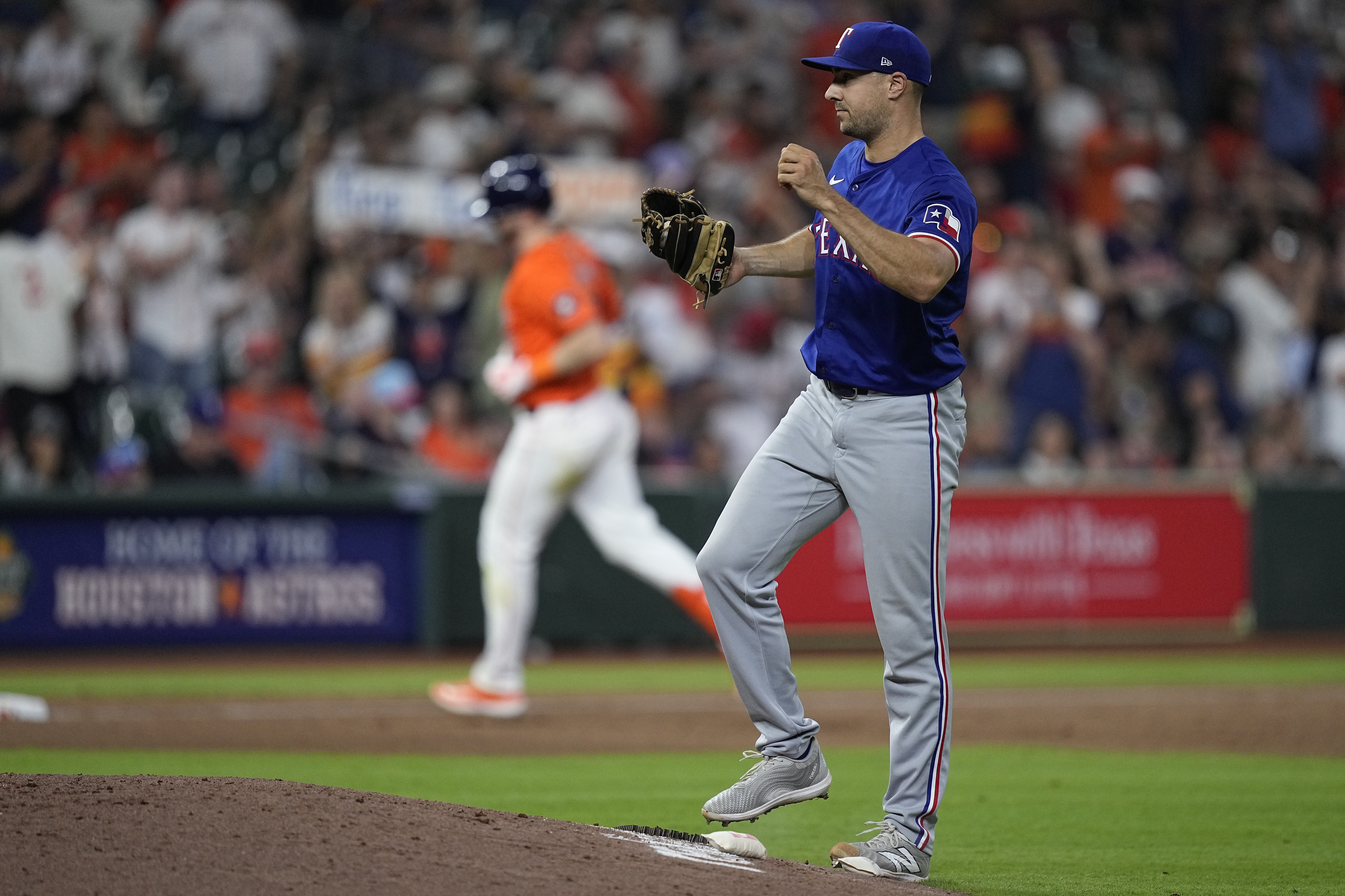 Texas Rangers relief pitcher Brock Burke reacts after giving up a two-run home run to Houston Astros' Kyle Tucker during the seventh inning of a baseball game Friday, April 12, 2024, in Houston.
