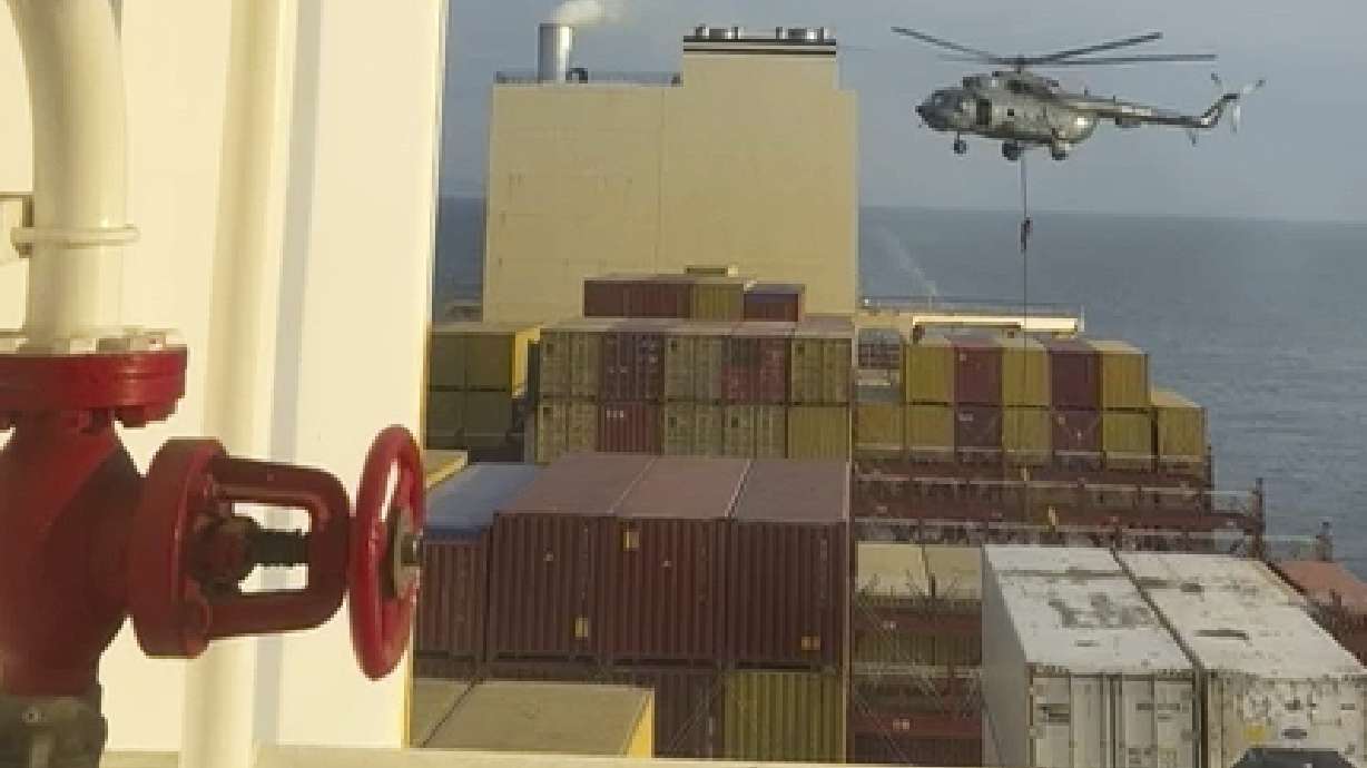 This image made from a video provided AP by a Mideast defense official shows a helicopter raid targeting a vessel near the Strait of Hormuz on Saturday. Booms and air raid sirens have sounded in Jerusalem after Iran launched dozens of drones and ballistic missiles toward Israel in an unprecedented revenge mission.