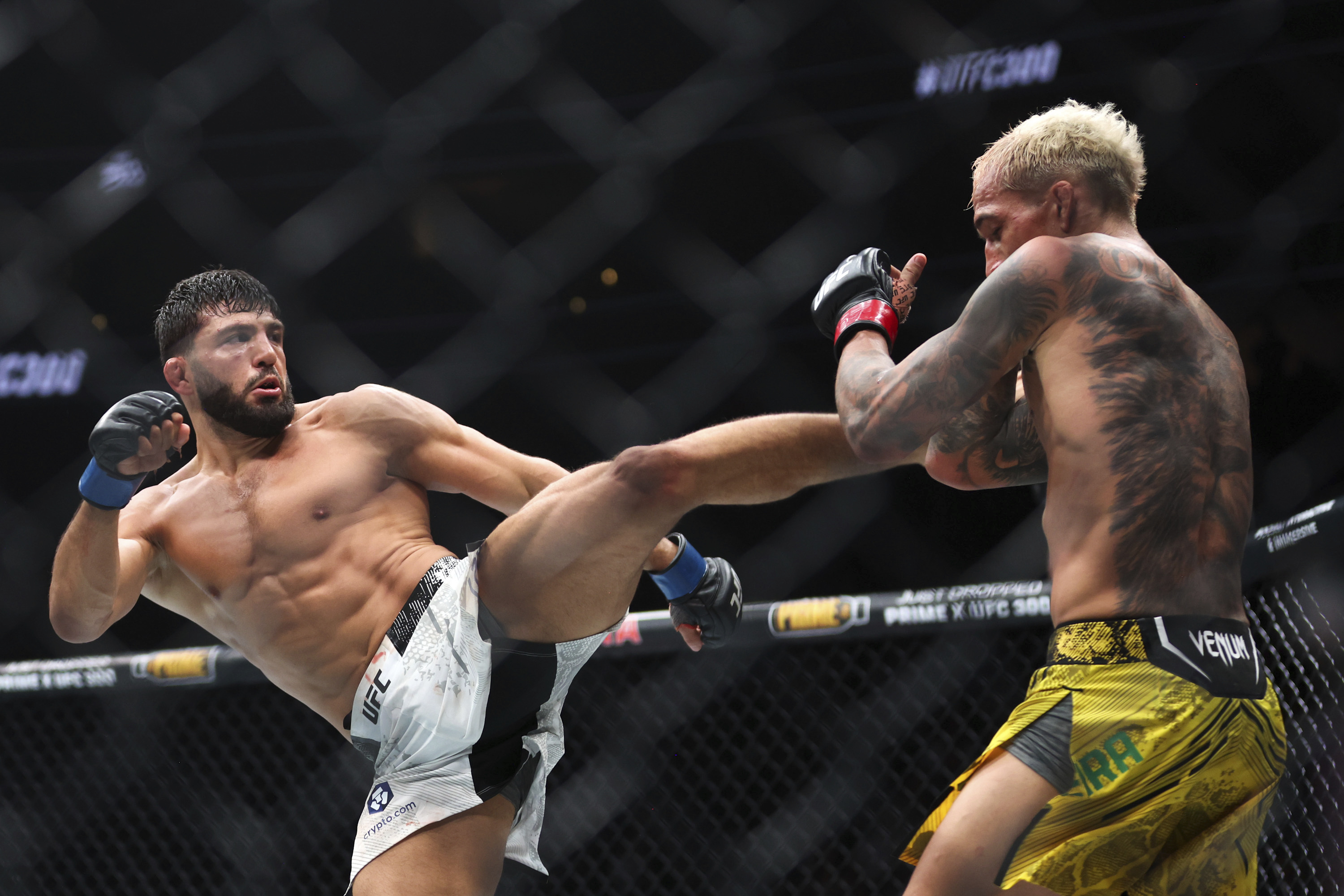 Arman Tsarukyan, left, kicks Charles Oliveira during a UFC 300 mixed martial arts lightweight bout Saturday, April 13, 2024, in Las Vegas. 