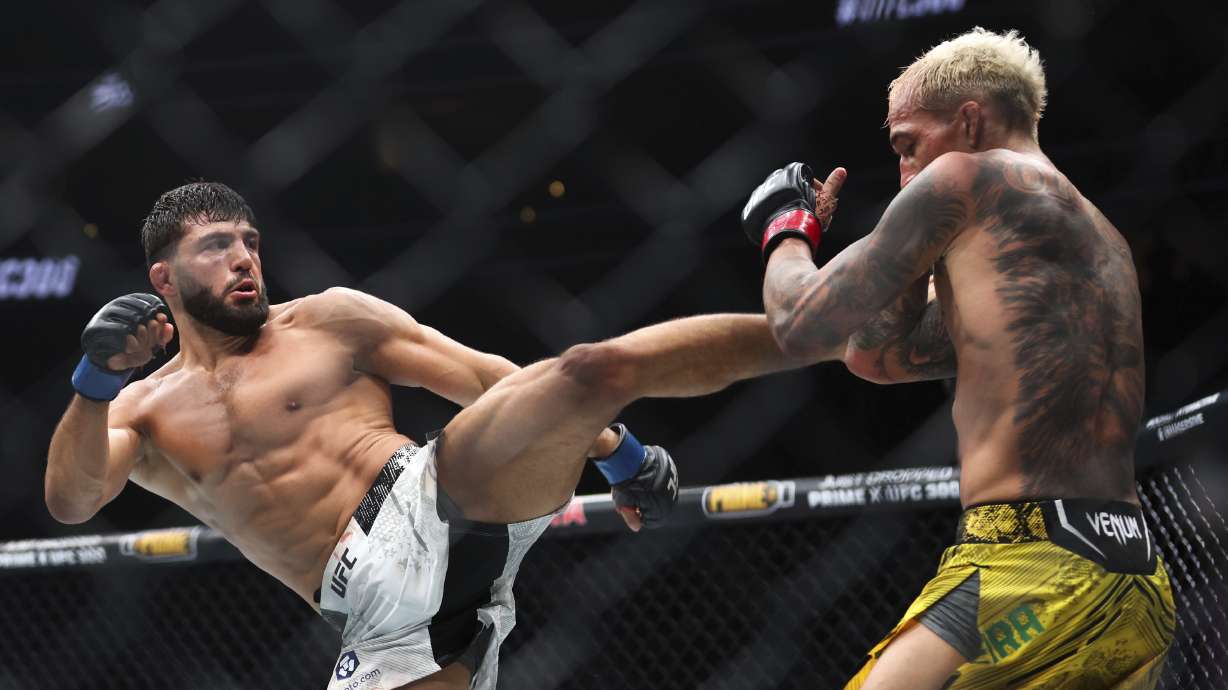 Arman Tsarukyan, left, kicks Charles Oliveira during a UFC 300 mixed martial arts lightweight bout Saturday, April 13, 2024, in Las Vegas.