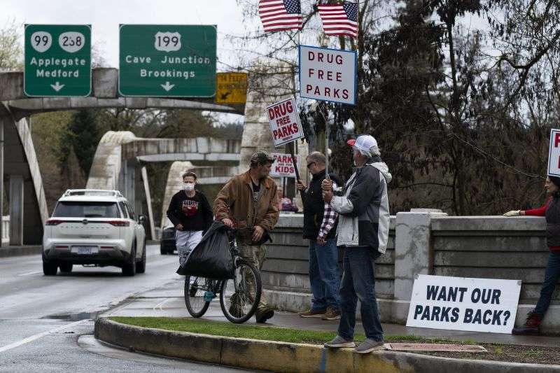 Members of the self-proclaimed "park watch" group protest on March 22, in Grants Pass, Ore.