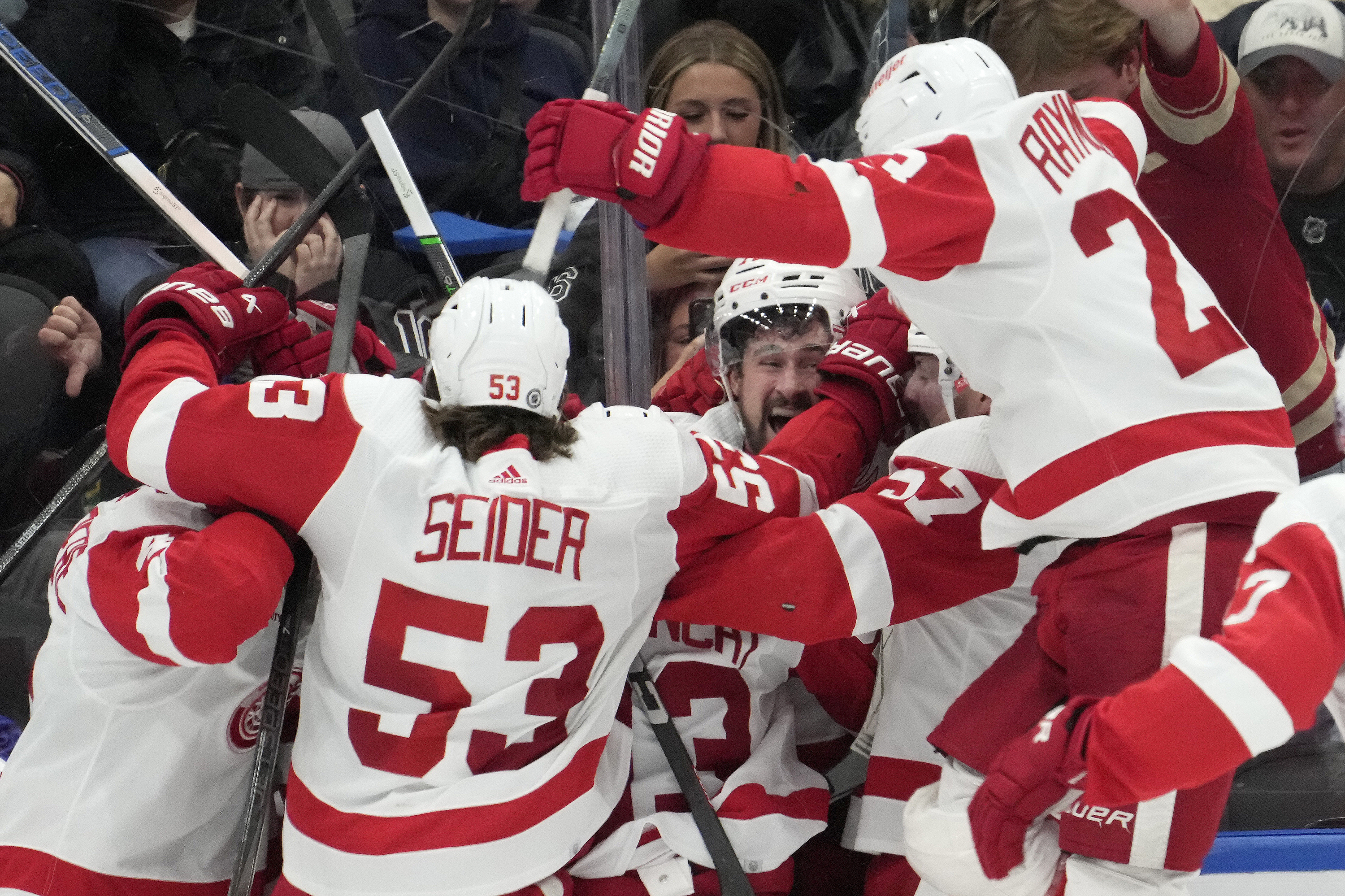 Detroit Red Wings center Dylan Larkin (71) celebrates with teammates after scoring against the Toronto Maple Leafs in overtime of an NHL hockey game Saturday, April 13, 2024, in Toronto.