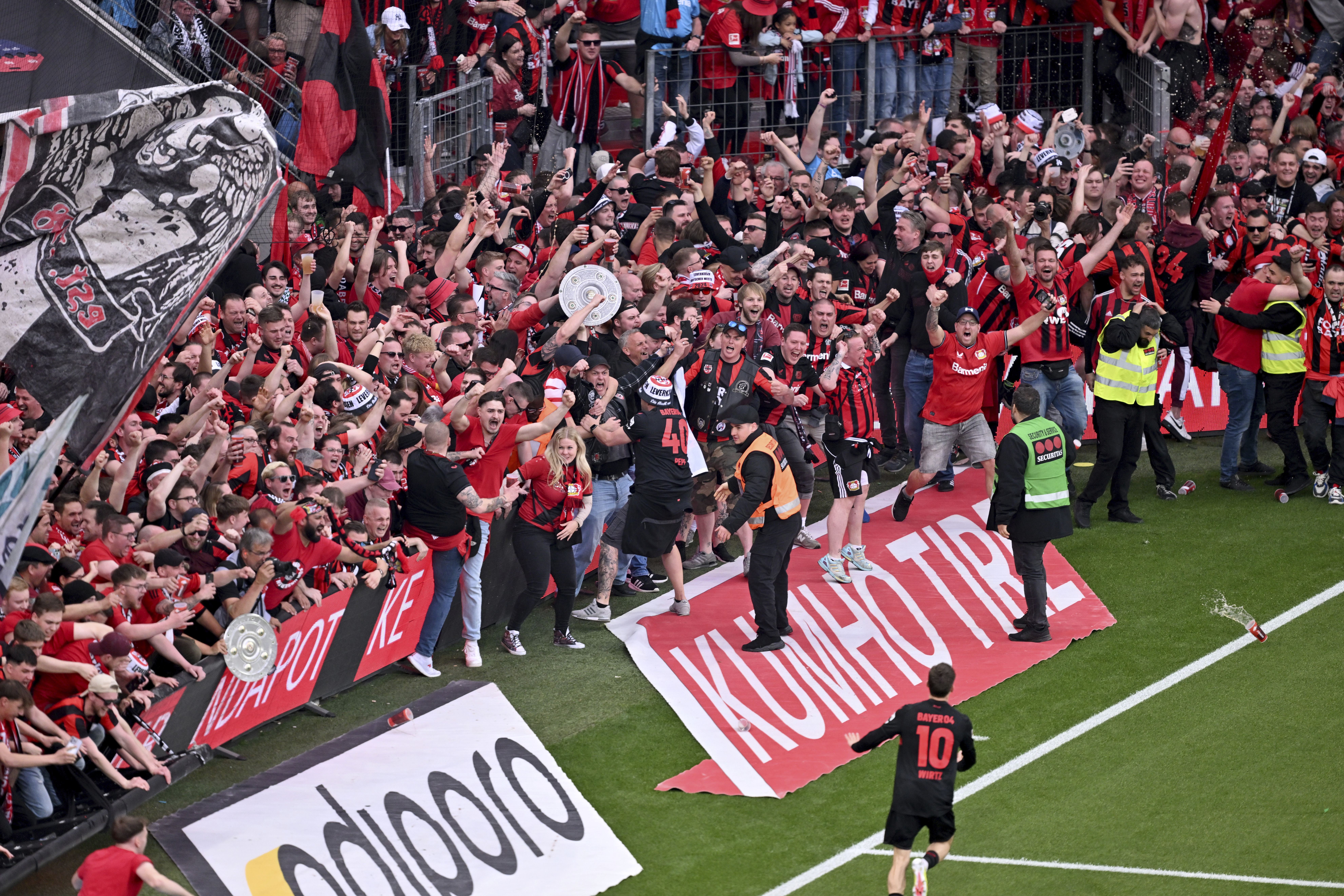 Leverkusen's Florian Wirtz, bottom, celebrates after scoring his side's fourth goal of the game during the Bundesliga soccer match between Bayer Leverkusen and Werder Bremen at the BayArena in Leverkusen, Germany, Sunday April 14, 2024.