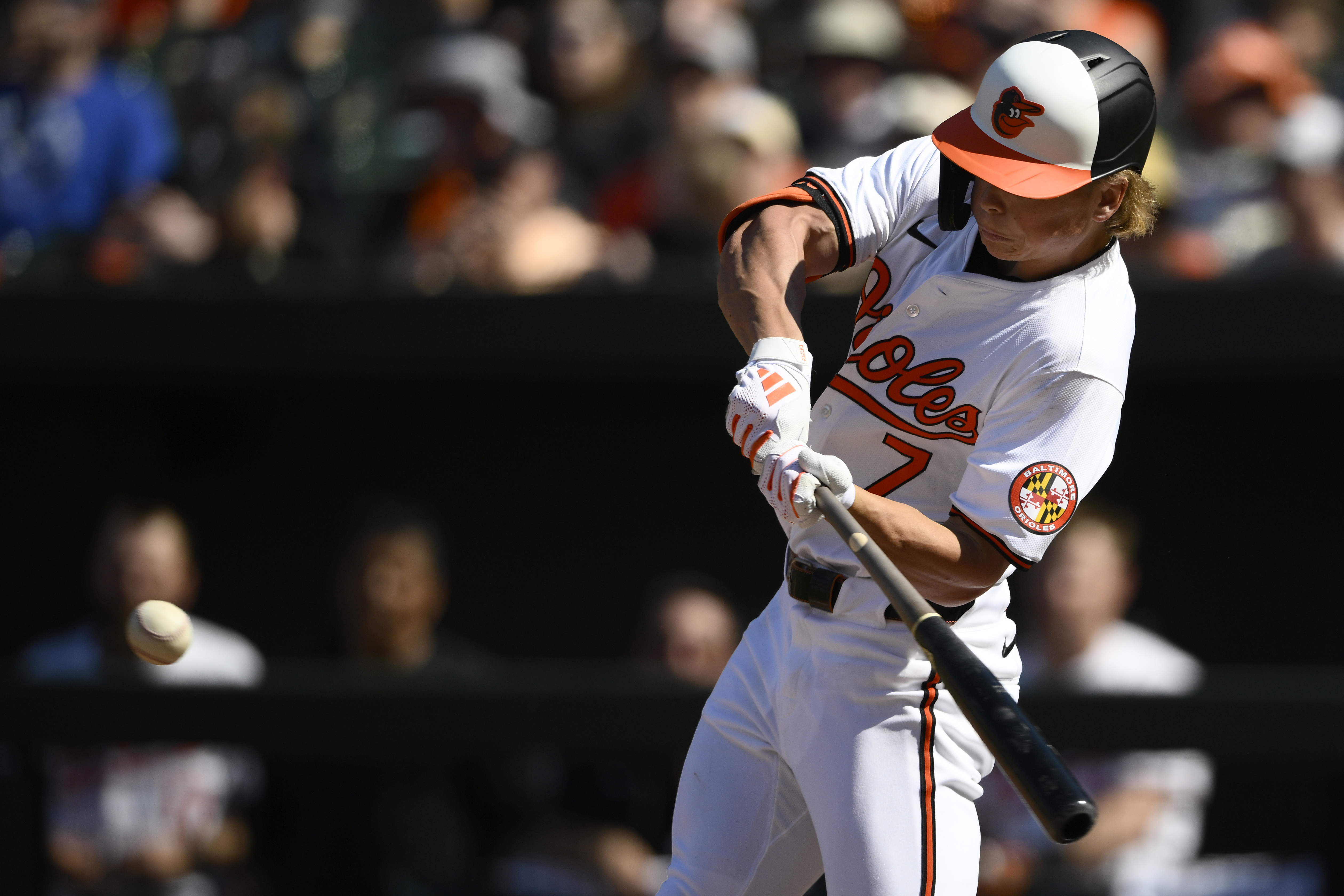Baltimore Orioles' Jackson Holliday swings for a single during the seventh inning of a baseball game against the Milwaukee Brewers, Sunday, April 14, 2024, in Baltimore. This was his first major league hit.