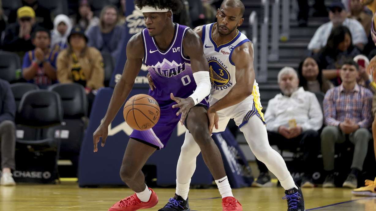 Utah Jazz forward Taylor Hendricks (0) is defended by Golden State Warriors guard Chris Paul (3) during the first half of an NBA basketball game in San Francisco, Sunday, April 14, 2024.
