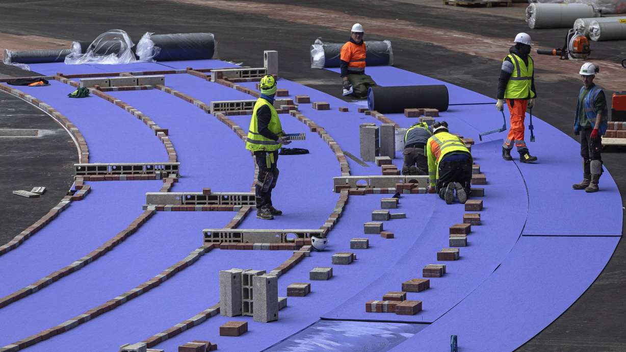 The purple athletics track at the Olympic Stadium, currently known as Stade de France, is being installed, in Saint-Denis, north of Paris, Tuesday, April 9, 2024. The Olympic Stadium will host the athletics events at the Paris 2024 Olympic Games.