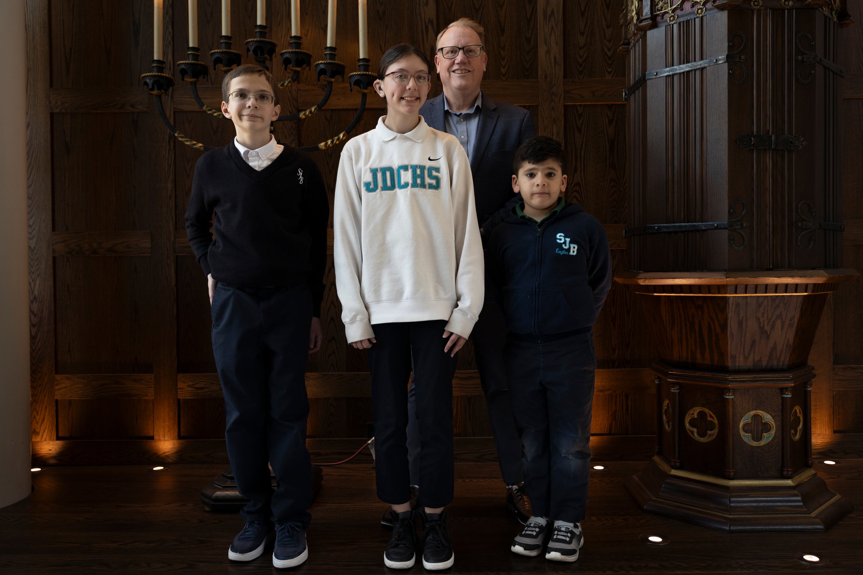 Gabe Flanigan, Brooklynn Lee and Gael Martinez Medina pose for a portrait with Ronnie Daniel, executive director of the Children First Education Fund, at Juan Diego Catholic High School in Draper on April 8. All three students are recipients of the Children First Education Fund scholarships that help with their schooling.