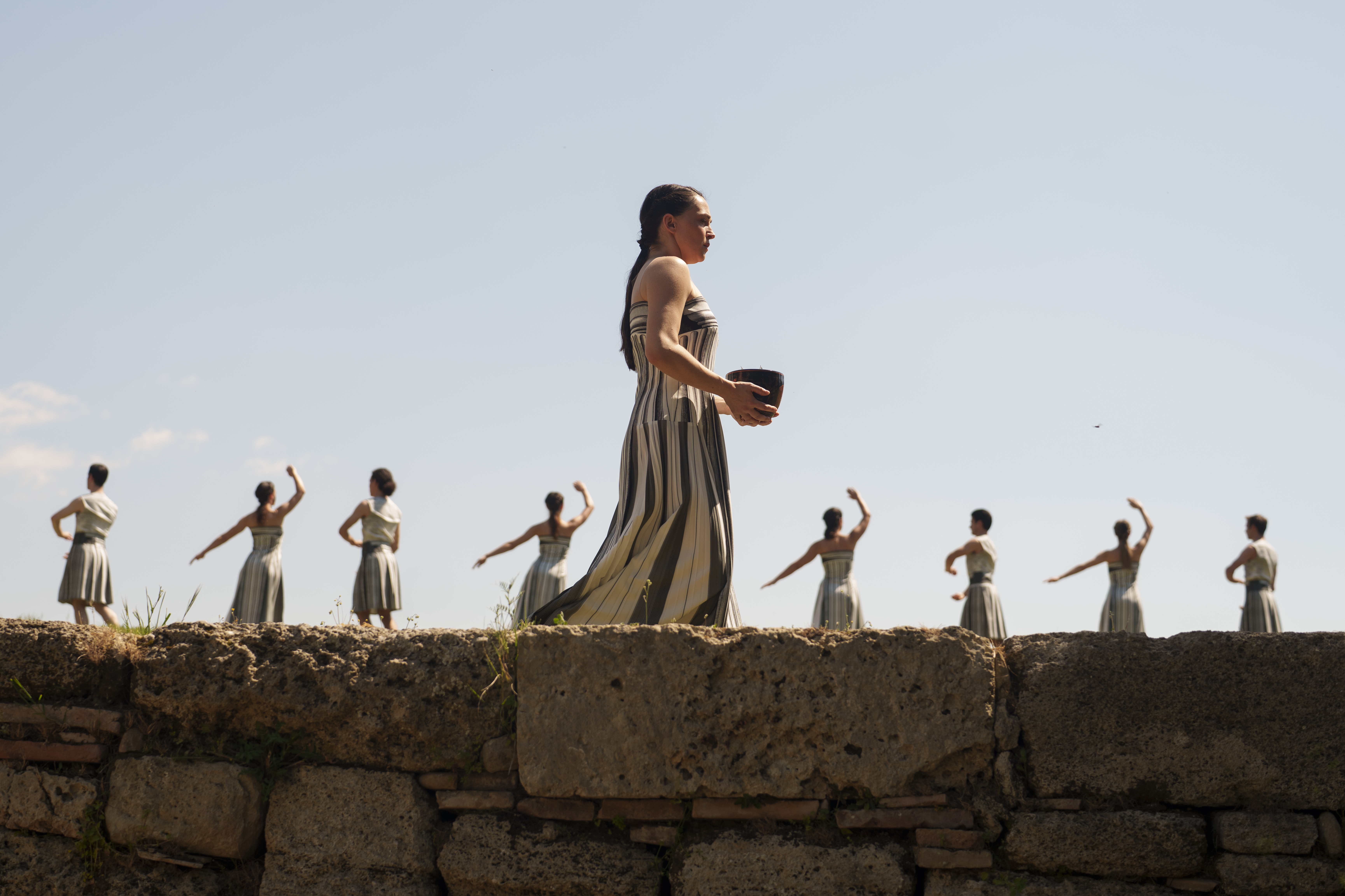 Performers, who will take part in the flame lighting ceremony for the Paris Olympics, join a rehearsal at Ancient Olympia site, Greece, Sunday, April 14, 2024. Every two years, a countdown to the Olympic games is launched from its ancient birthplace with a flame lighting ceremony in southern Greece at Ancient Olympia. The event is marked with a performance by dancers who assume the role of priestesses and male companions, their movement inspired by scenes on millennia-old artwork. 
