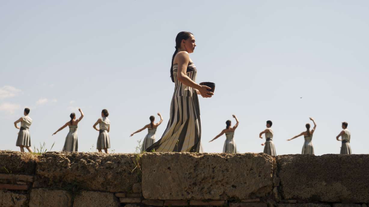 Performers, who will take part in the flame lighting ceremony for the Paris Olympics, join a rehearsal at Ancient Olympia site, Greece, Sunday, April 14, 2024. Every two years, a countdown to the Olympic games is launched from its ancient birthplace with a flame lighting ceremony in southern Greece at Ancient Olympia. The event is marked with a performance by dancers who assume the role of priestesses and male companions, their movement inspired by scenes on millennia-old artwork.