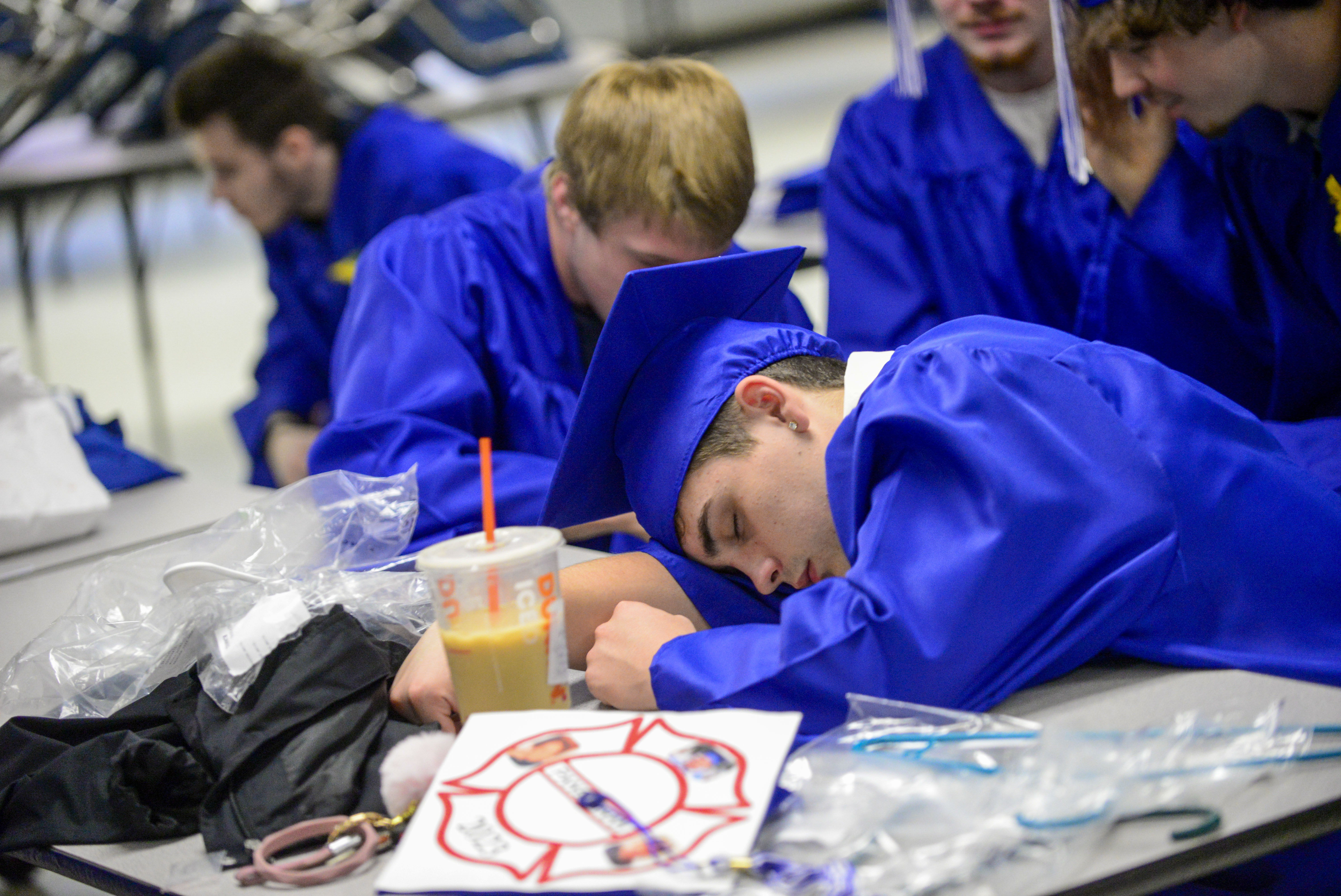 Chad Burnett, a graduating senior from Hinsdale, N.H. Middle High School, takes a small nap before the commencement ceremony on June 17, 2023. The Gallup survey, released Monday, says that a majority of Americans say they would feel better if they could have more sleep.