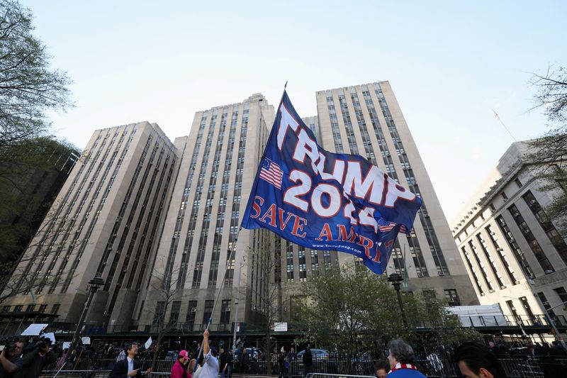 A supporter of Republican presidential candidate and former President Donald Trump waves a flag on the day of his hush money criminal trial, in New York City, Monday.