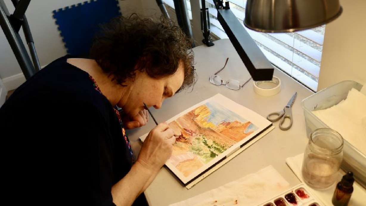 Artist Kimberly Jackson works on a painting inside her home in Washington, Washington County, Feb. 29.