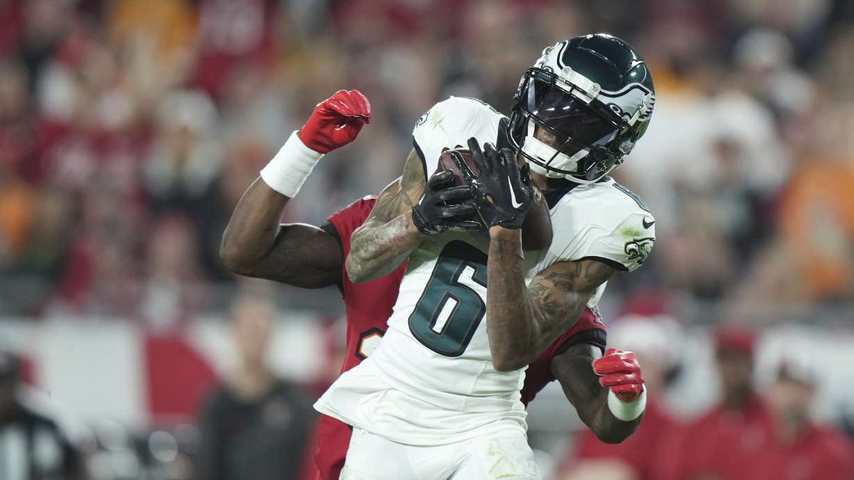 FILE - Philadelphia Eagles wide receiver DeVonta Smith (6) catches a deep pass as Tampa Bay Buccaneers cornerback Jamel Dean (35) defends during an NFL wild-card playoff football game, Monday, Jan. 15, 2024, in Tampa, Fla. The Philadelphia Eagles agreed to terms with wide receiver DeVonta Smith on a three-year contract extension through the 2028 season on Monday, April 15, 2024.