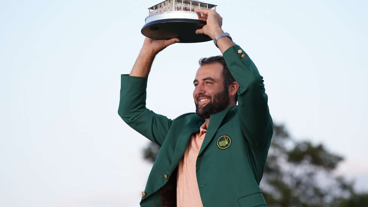 Scottie Scheffler holds the trophy after winning the Masters golf tournament at Augusta National Golf Club Sunday, April 14, 2024, in Augusta, Ga.