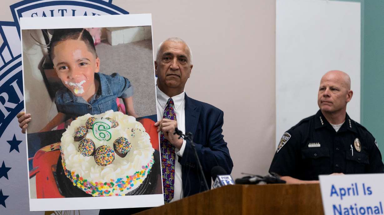 District Attorney Sim Gill holds up a photograph of Norlin, a 6-year-old who was killed by his mother, during a Child Abuse Prevention Month press conference at the Salt Lake County District Attorney’s Office in Salt Lake City on Monday.