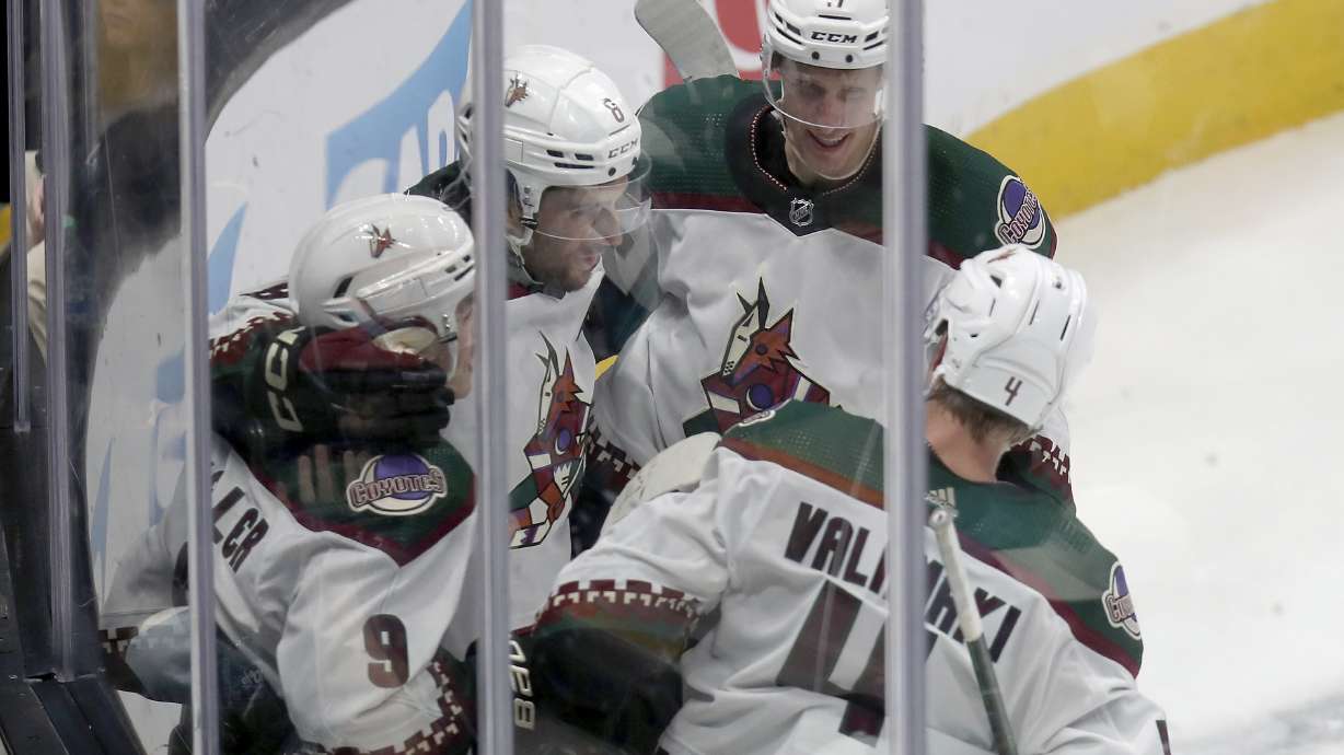 Arizona Coyotes right wing Clayton Keller (9) celebrates with teammates after a goal in an NHL hockey game against the San Jose Sharks in San Jose, Calif., Sunday, April 7, 2024.