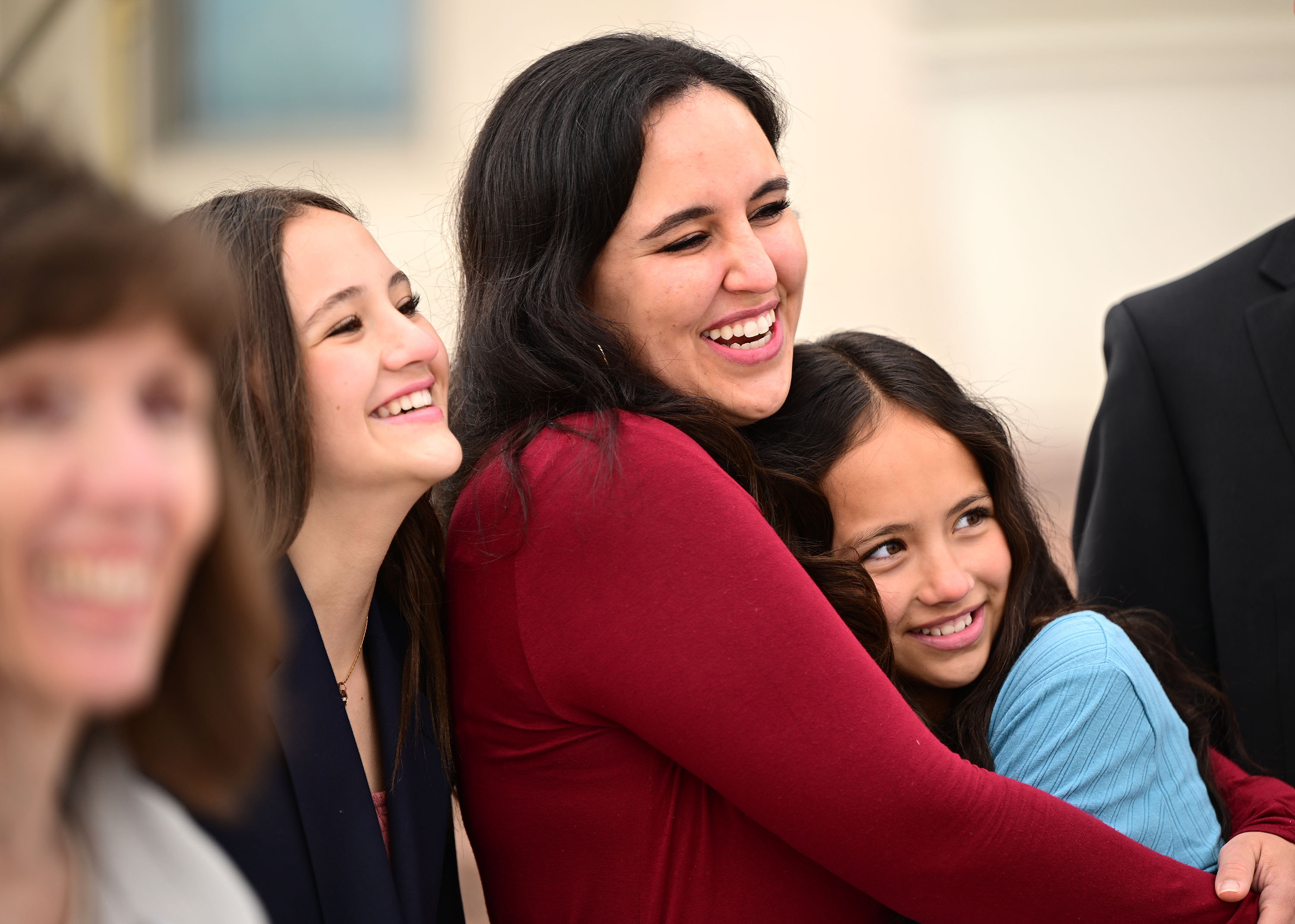 Eva, Sarah and Isabella Tarma smile as they talk with friends outside the Layton temple during media day on Monday.