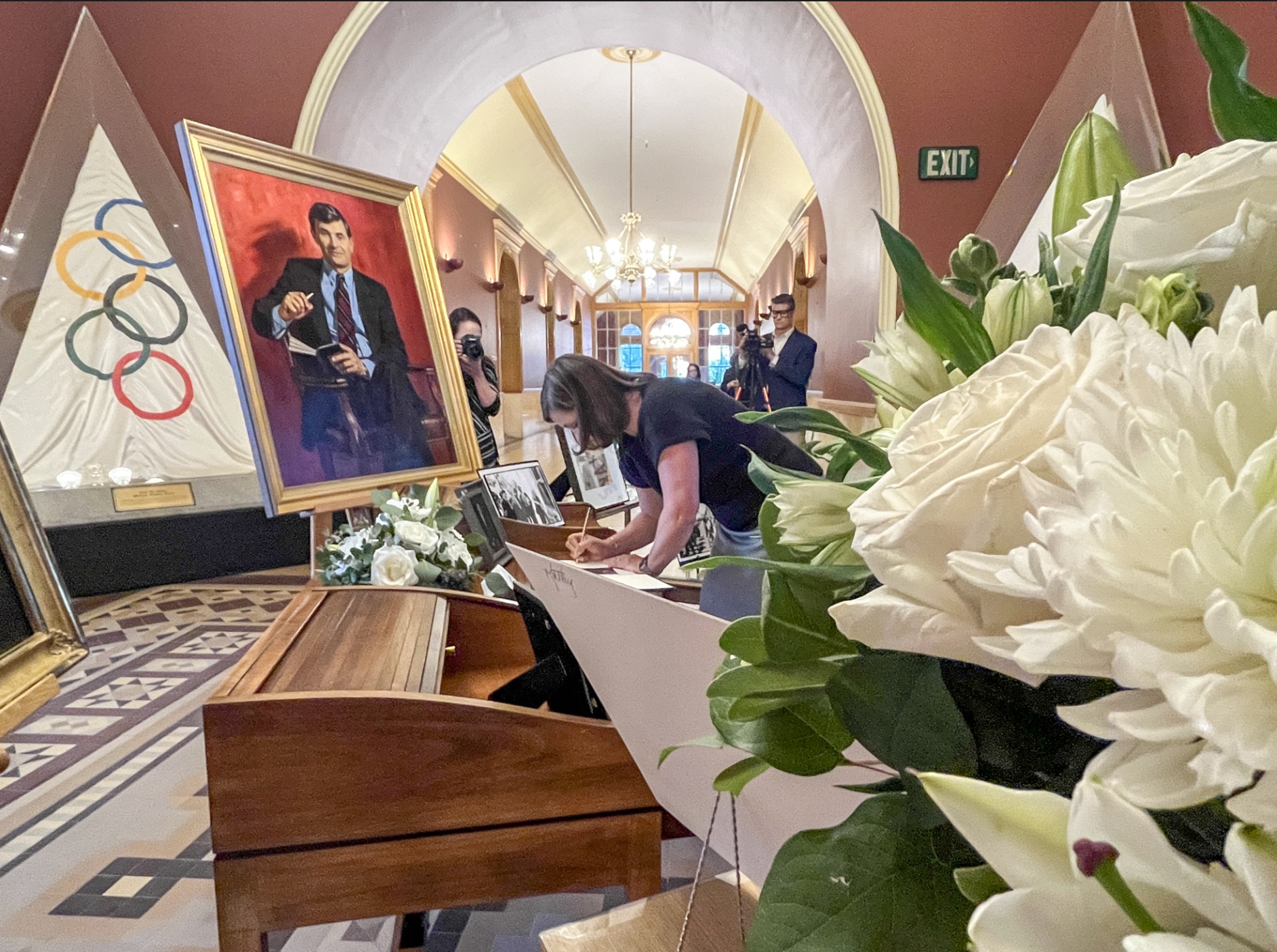 Salt Lake County Mayor Jenny Wilson leaves a message for her father, Ted Wilson, in a guest book at the Salt Lake City & County Building on Monday. Ted Wilson, a former Salt Lake City mayor and respected member of Utah politics, died on Thursday at the age of 84.