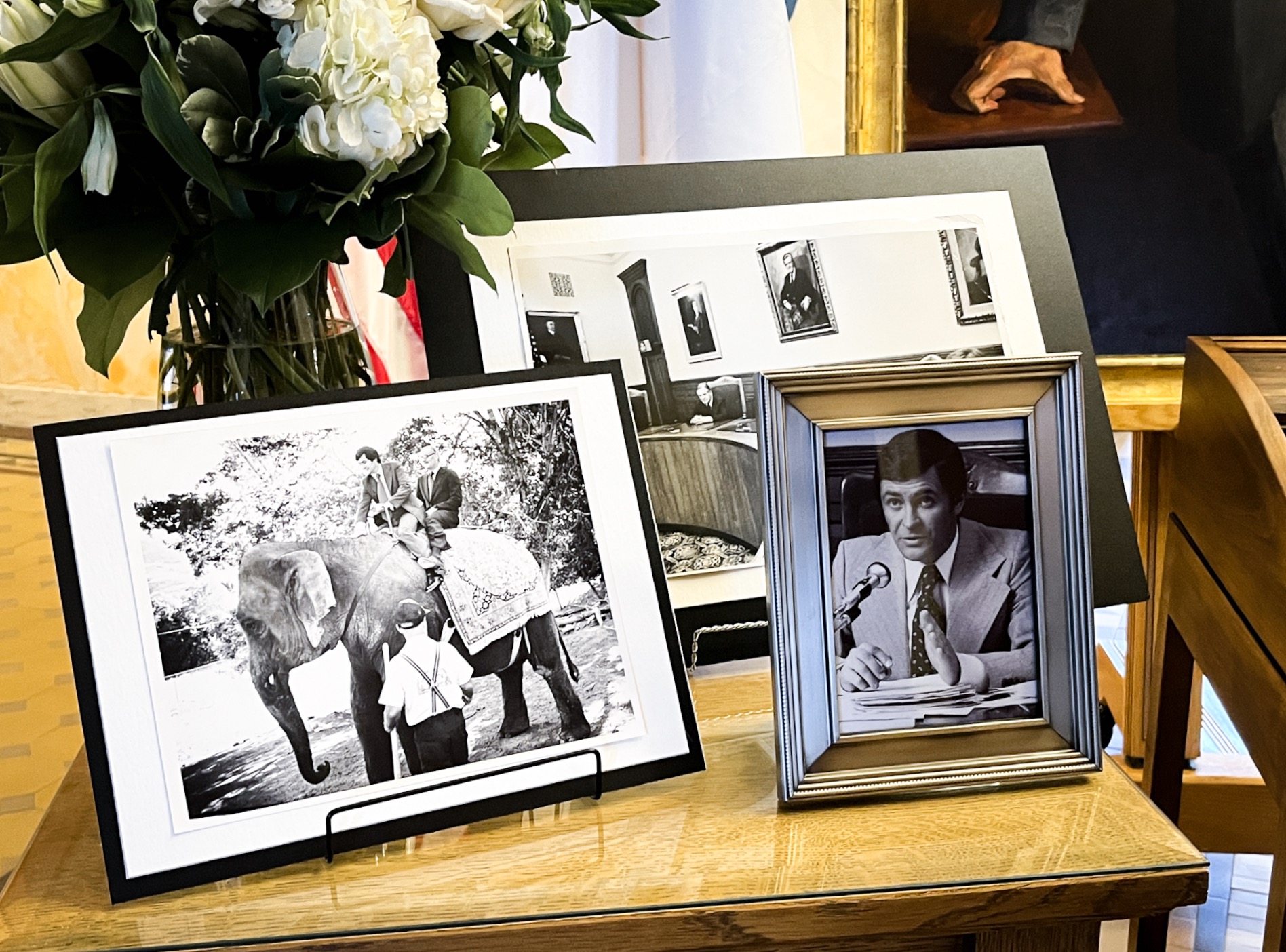 Photos of Ted Wilson during his time as Salt Lake City mayor are placed on a table near his old desk inside the Salt Lake City-County Building on Monday. Wilson died on Thursday at the age of 84.