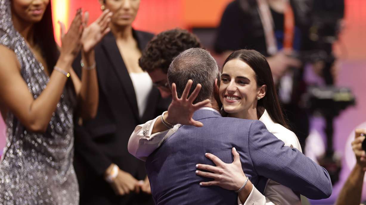 Iowa's Caitlyn Clark hugs her father, Brent Clark, after being selected first overall by the Indiana Fever during the first round of the WNBA basketball draft, Monday, April 15, 2024, in New York.