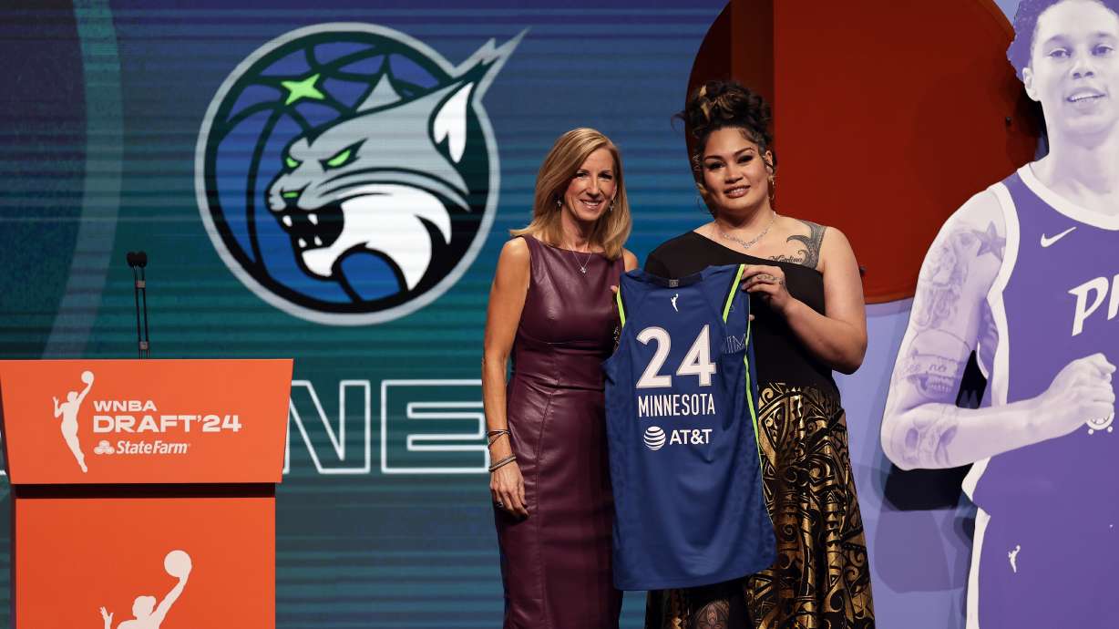 Utah's Alissa Pili, right, poses for a photo with WNBA commissioner Cathy Engelbert after being selected eighth overall by the Minnesota Lynx during the first round of the WNBA basketball draft on Monday, April 15, 2024, in New York.