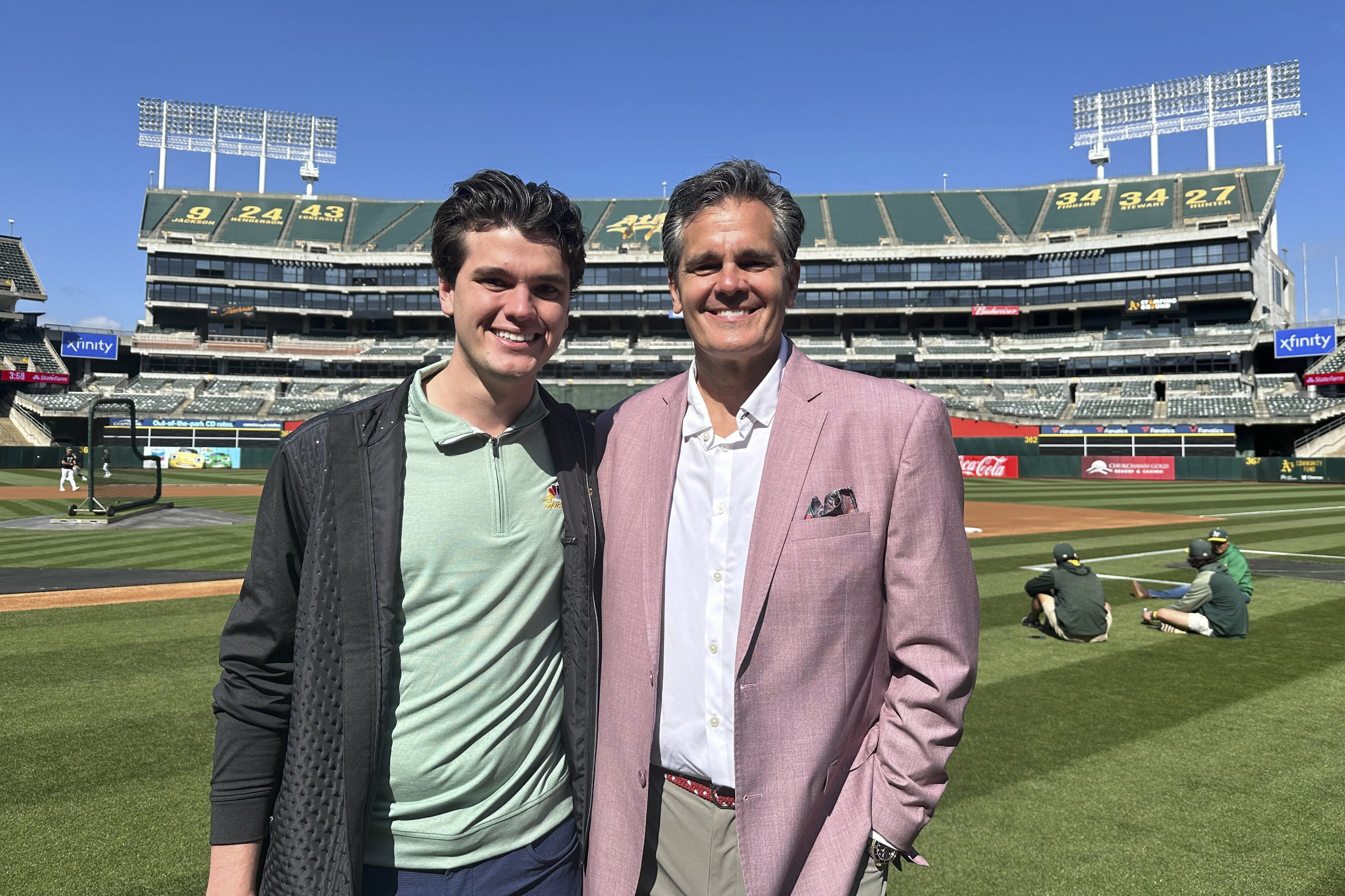 Oakland Athletics broadcaster Chris Caray, left, and his father, Chip, the play-by-play announcer for the St. Louis Cardinals, stand for a photo before the teams' baseball game Monday, April 15, 2024, in Oakland, Calif. 