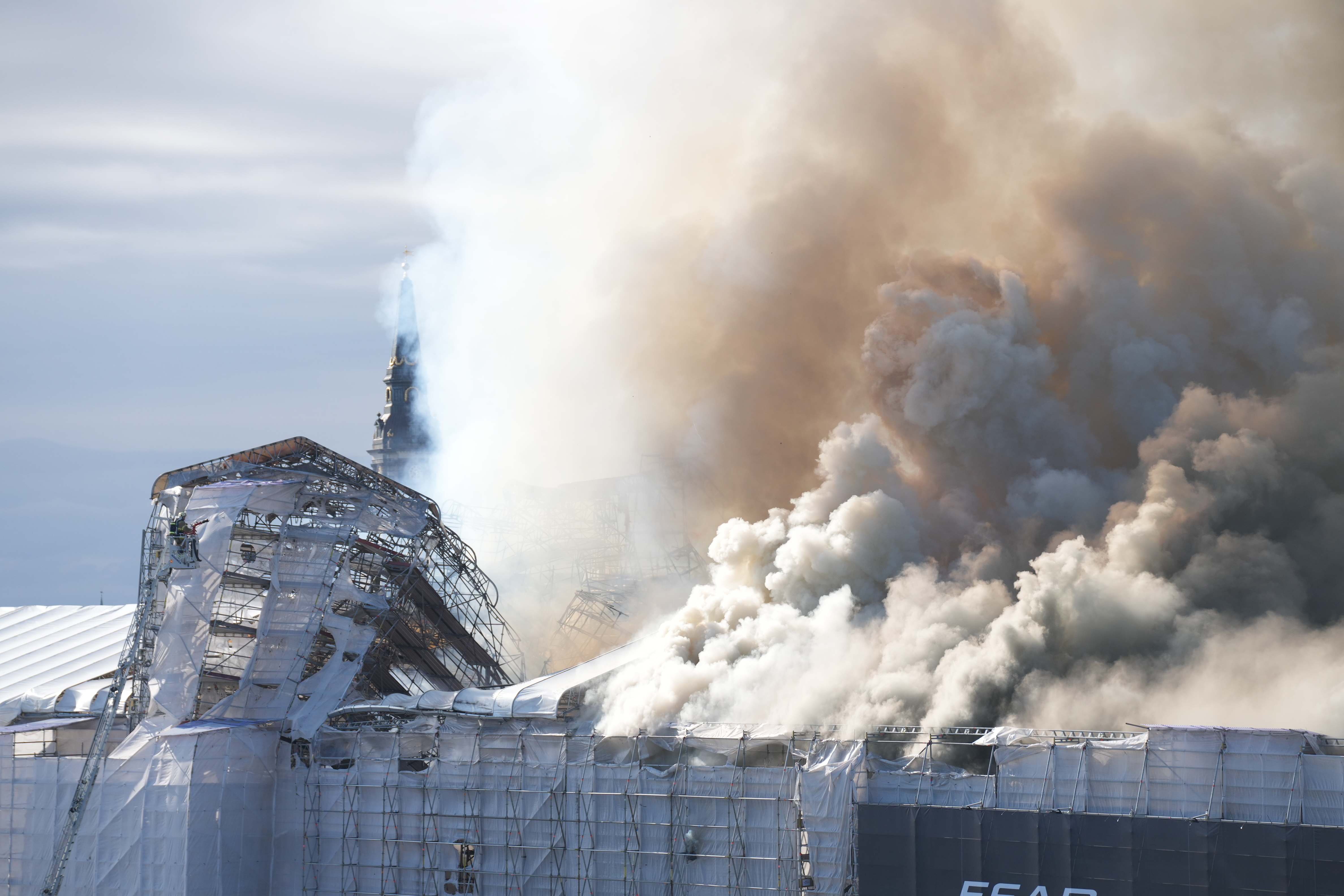 Smoke rises out of the Old Stock Exchange, Boersen, in Copenhagen, Denmark, Tuesday.