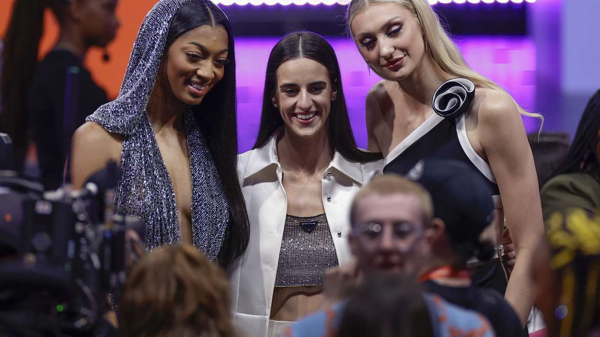 CORRECTS TO CAITLIN CLARK NOT CAITLYN CLARK - From left to right, LSU's Angel Reese, Iowa's Caitlin Clark and Stanford's Cameron Brink pose for a photo before the WNBA basketball draft, Monday, April 15, 2024, in New York.