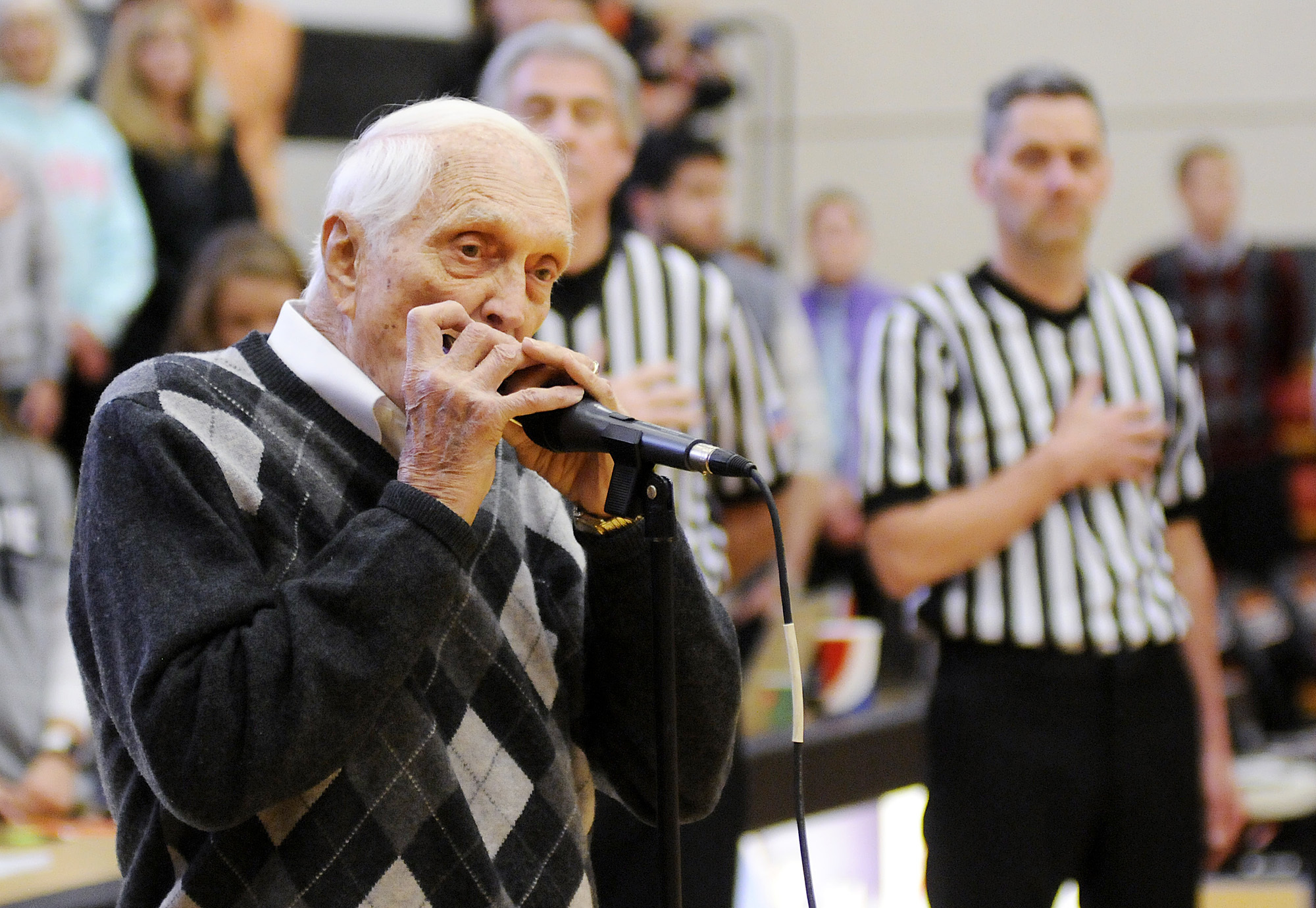 FILE - Former Brooklyn Dodgers baseball player Carl Erskine plays the national anthem on his harmonica before a college basketball game between Anderson and Franlin in Anderson, Ind., Saturday, Jan. 14, 2017. Carl Erskine, who pitched two no-hitters as a mainstay on the Brooklyn Dodgers and was a 20-game winner in 1953 when he struck out a then-record 14 in the World Series, died Tuesday, April 16, 2024, at Community Hospital Anderson in Anderson, Ind., according to Michele Hockwalt, the hospital’s marketing and communication manager. He was 97. 