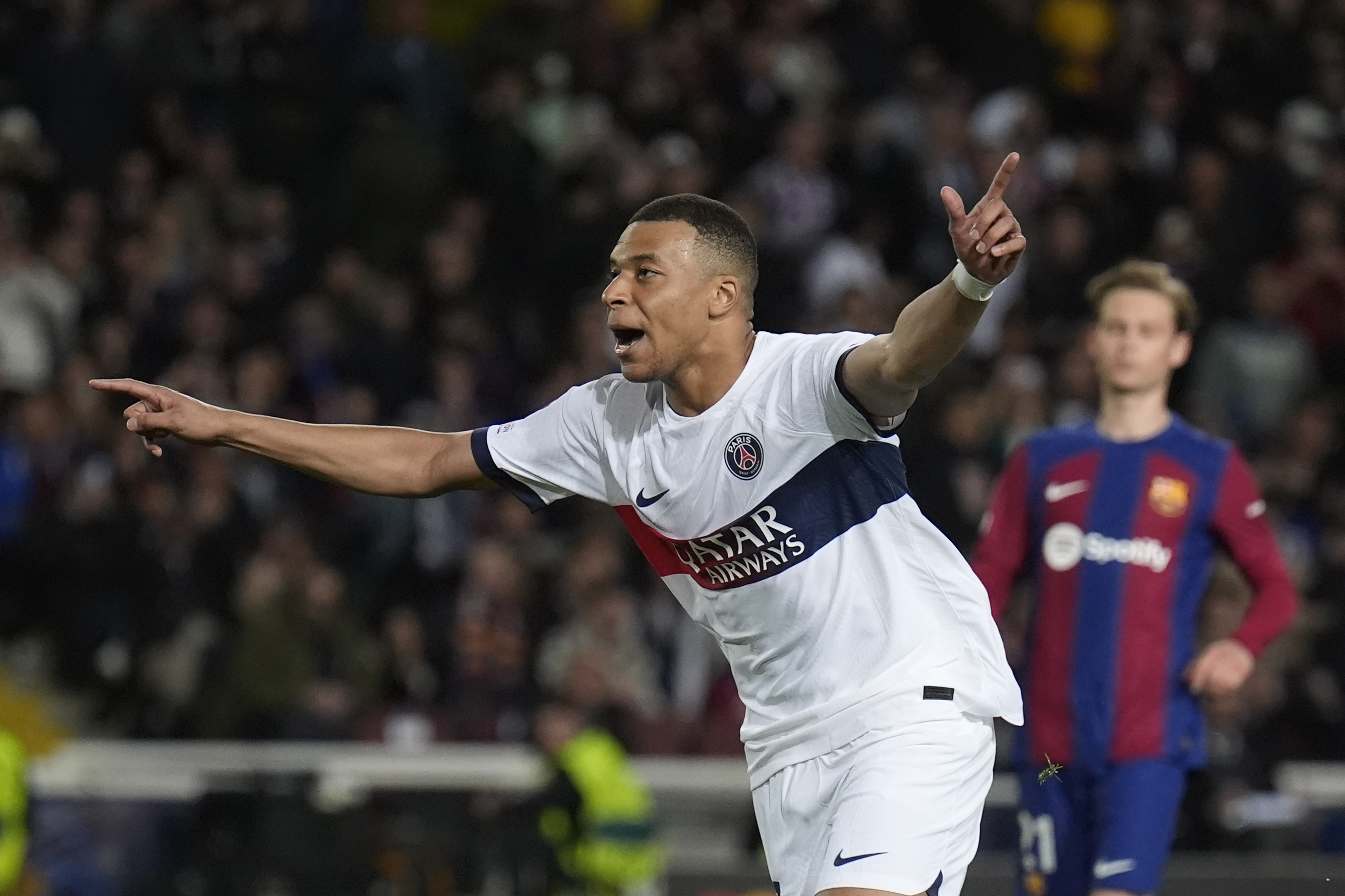 PSG's Kylian Mbappe celebrates after scoring his side's third goal during the Champions League quarterfinal second leg soccer match between Barcelona and Paris Saint-Germain at the Olimpic Lluis Companys stadium in Barcelona, Spain, Tuesday, April 16, 2024.