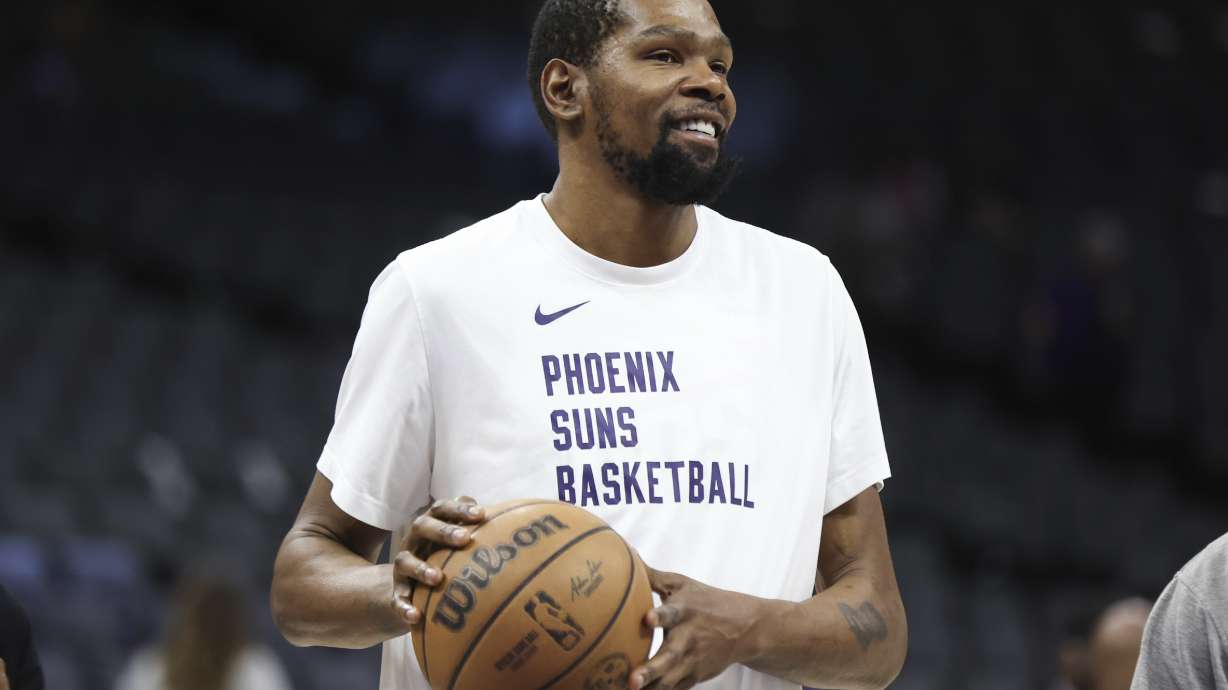 Phoenix Suns forward Kevin Durant gestures during warmups before an NBA basketball game against the Sacramento Kings Friday, April 12, 2024, in Sacramento, Calif.