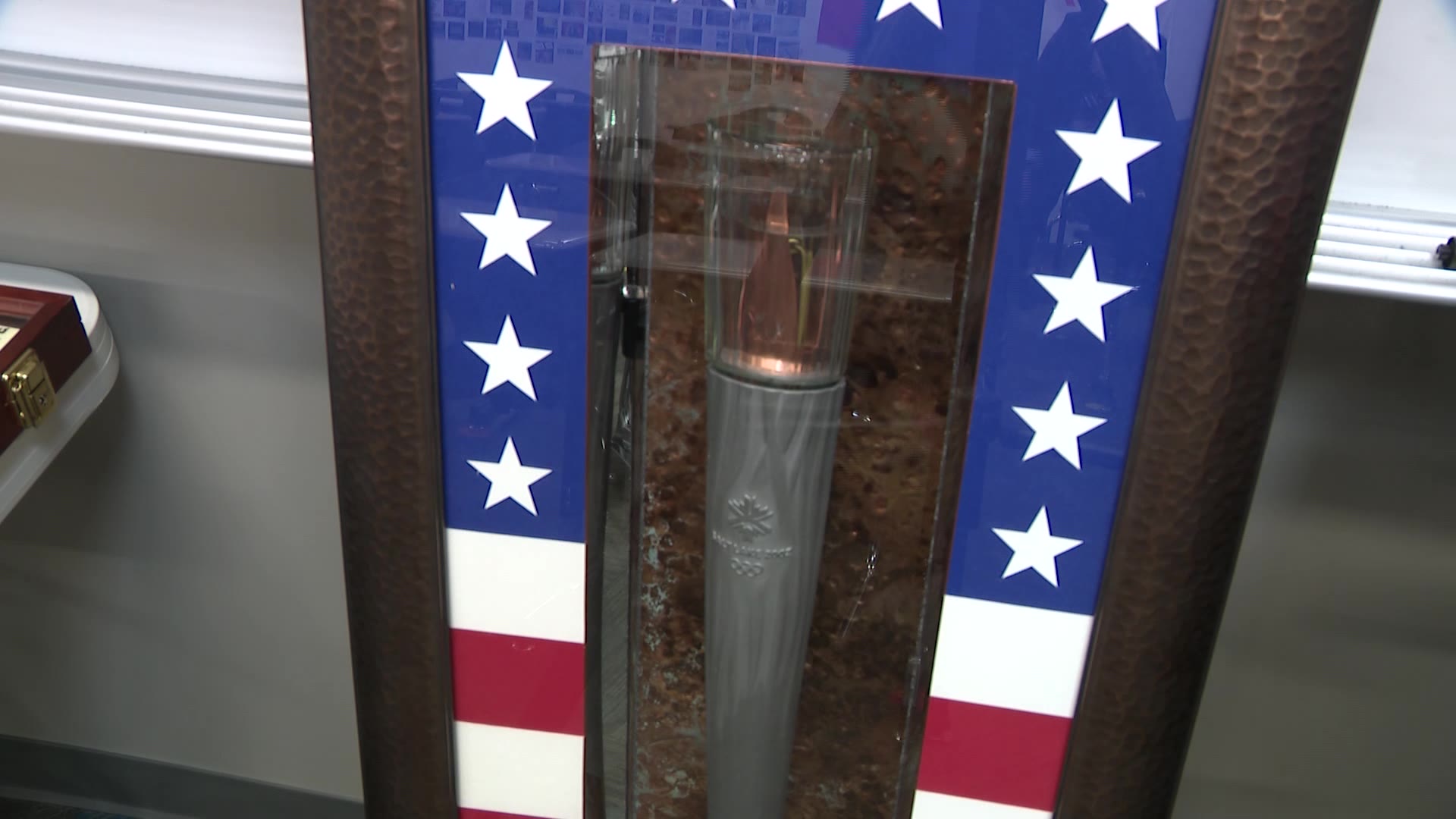 A 2002 Winter Games Olympic torch is displayed in the classroom.