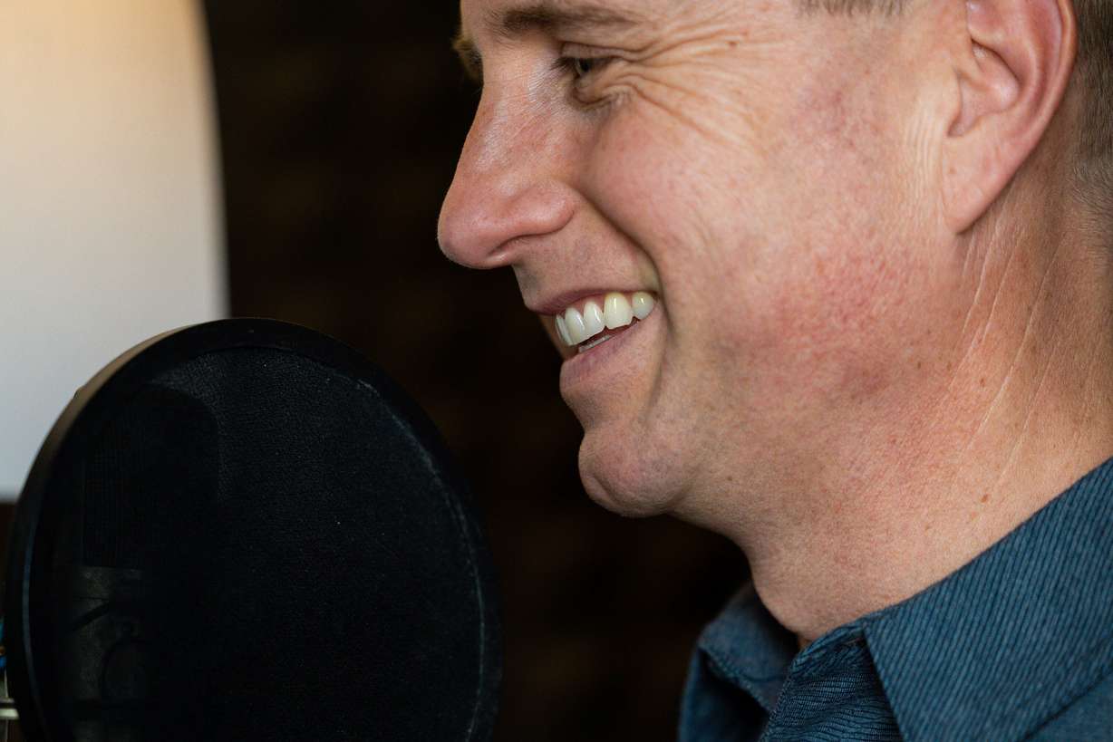 Kirby Heyborne mocks his audio recording setup for a portrait in his home in American Fork on Friday.