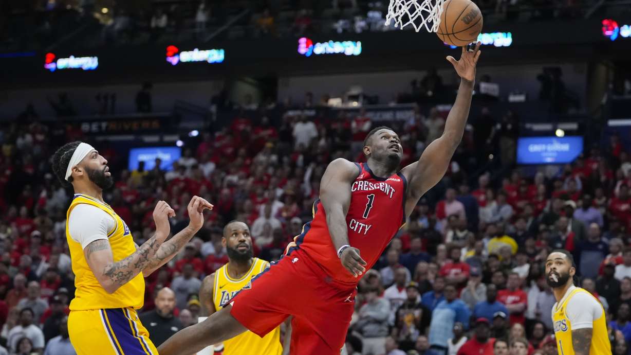 New Orleans Pelicans forward Zion Williamson (1) goes to the basket ahead of Los Angeles Lakers forward Anthony Davis in the second half of an NBA basketball play-in tournament game Tuesday, April 16, 2024, in New Orleans. The Lakers won 110-106.