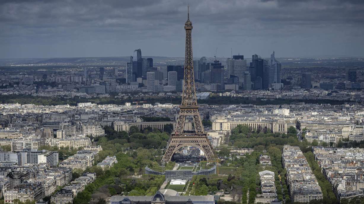 Stands are under construction on the Champ-de-Mars with the Eiffel Tower, Monday, April 15, 2024 in Paris. The Champ-de-Mars will host the Beach Volleyball and Blind Football at the Paris 2024 Olympic and Paralympic Games. Le Defense business district is seen in background.