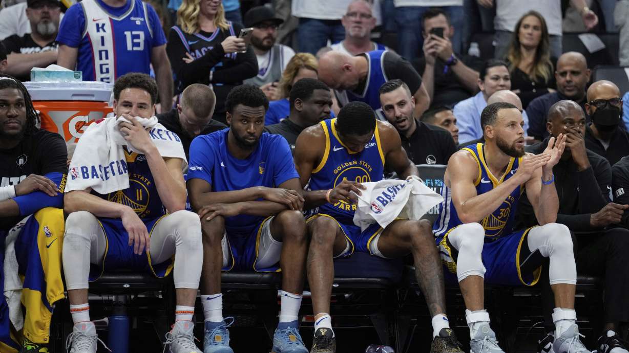 Golden State Warriors guards Klay Thompson, second from left, and Stephen Curry, second from right, sit on the bench during the second half of the team's NBA basketball play-in tournament game against the Sacramento Kings, Tuesday, April 16, 2024, in Sacramento, Calif.