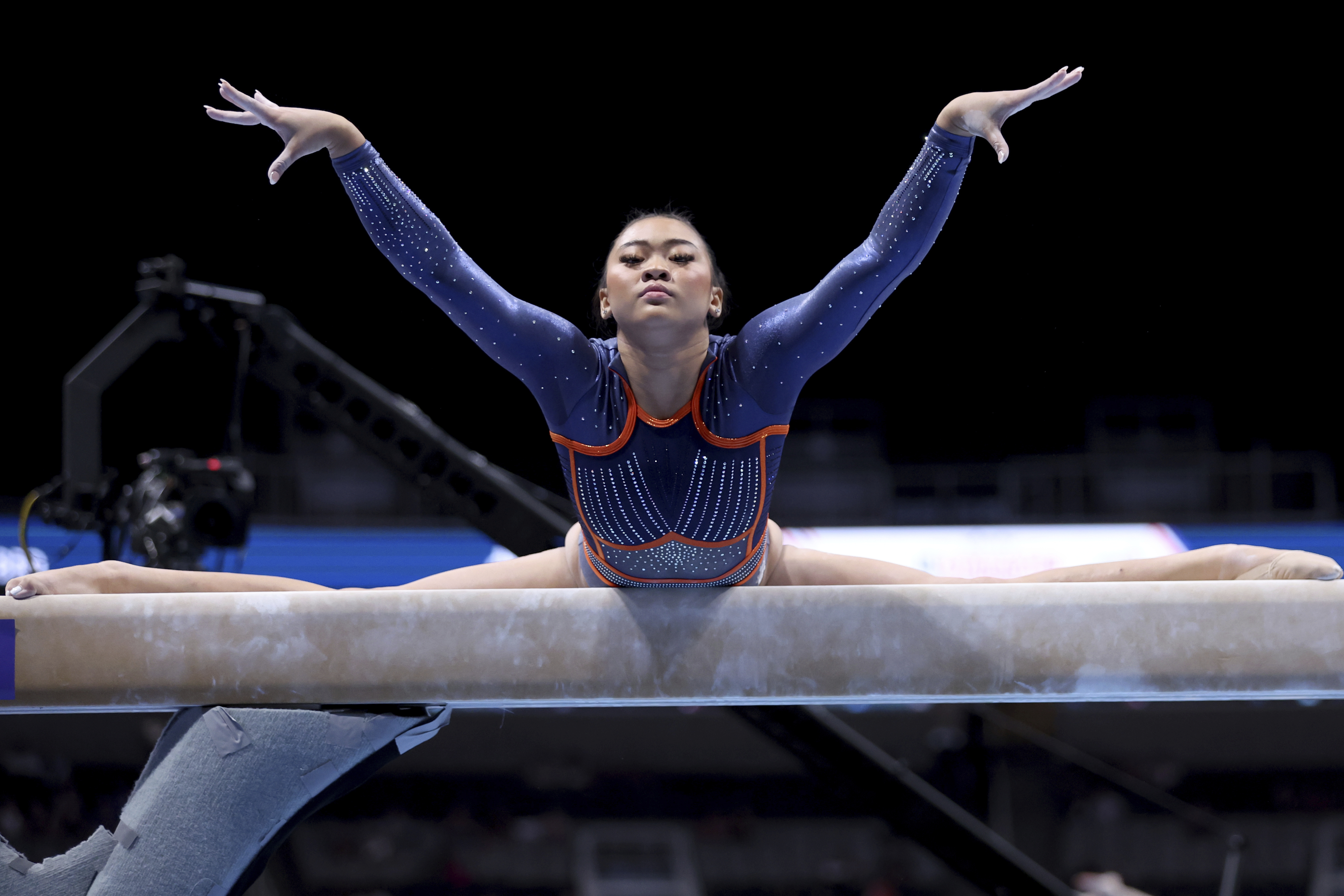 FILE - Suni Lee competes on the balance beam at the U.S. Gymnastics Championships, Friday, Aug. 25, 2023, in San Jose, Calif. Olympic gymnastics all-around champion Suni Lee revealed this week that at the height of a mystery kidney ailment last year, she gained around 45 pounds in water weight that made her question whether a return to top form was even possible.