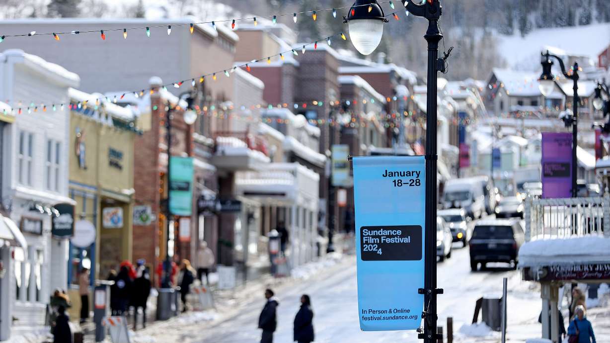 Signs are posted for the 2024 Sundance Film Festival on Main Street in Park City on Jan. 18. The festival announced Wednesday it is gathering proposals to determine where its future home will be.
