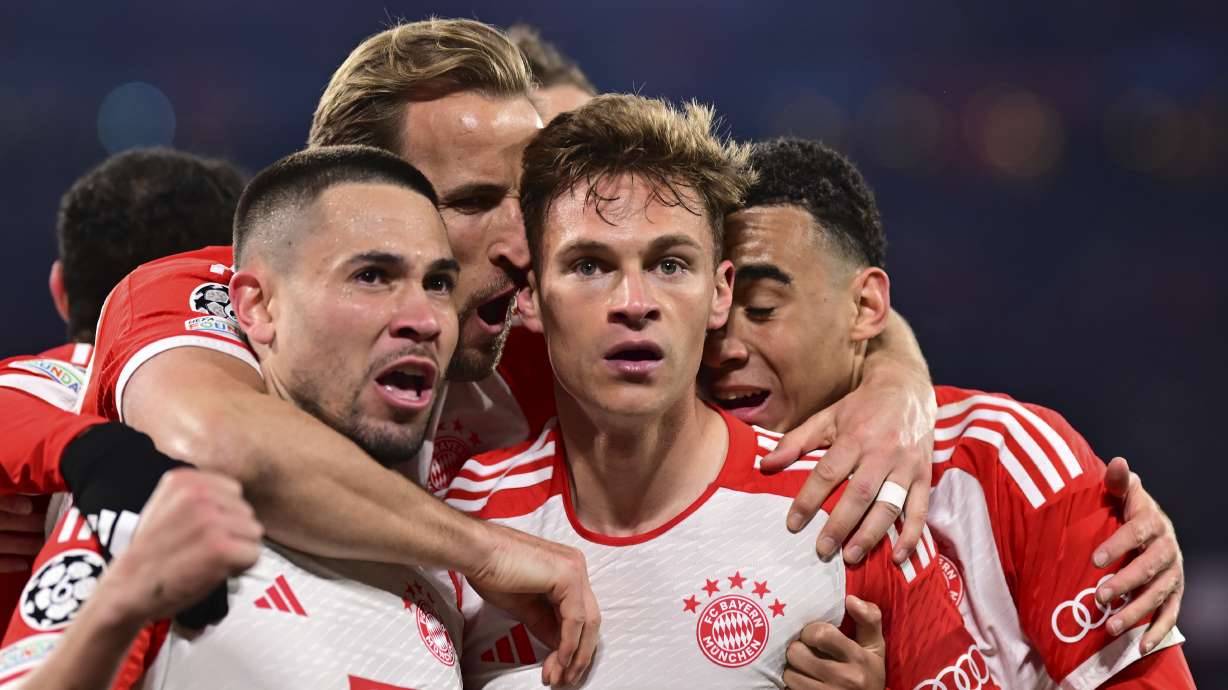 Bayern's Joshua Kimmich, centre, celebrates with teammates after scoring his side's opening goal during the Champions League quarter final second leg soccer match between Bayern Munich and Arsenal at the Allianz Arena in Munich, Germany, Wednesday, April 17, 2024.