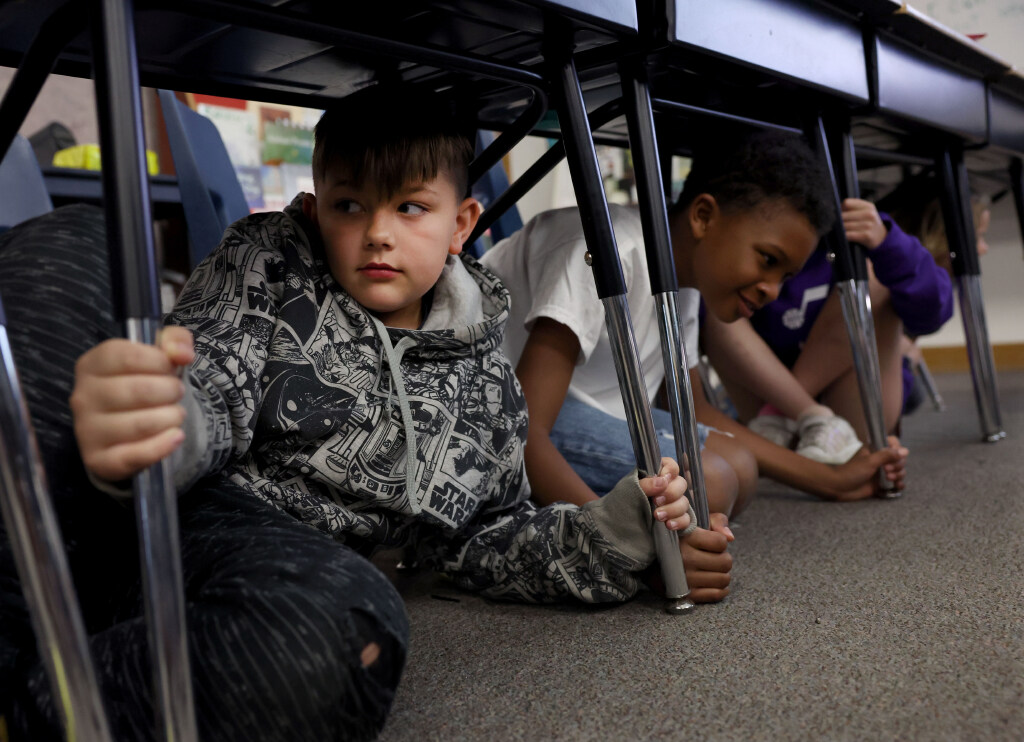 Third-graders Jack Deforest and Dean Gay participate in the Great Utah ShakeOut earthquake drill at Canyon View Elementary School in Cottonwood Heights on Thursday.