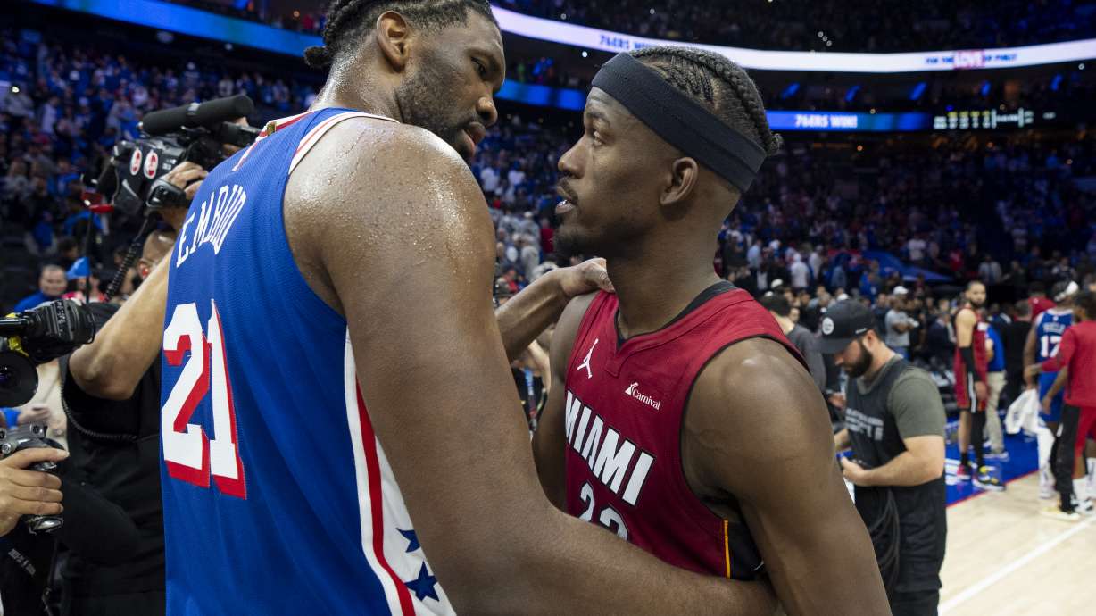 Philadelphia 76ers' Joel Embiid, left, talks with Miami Heat's Jimmy Butler following an NBA basketball play-in tournament game Wednesday, April 17, 2024, in Philadelphia. The 76ers won 105-104.