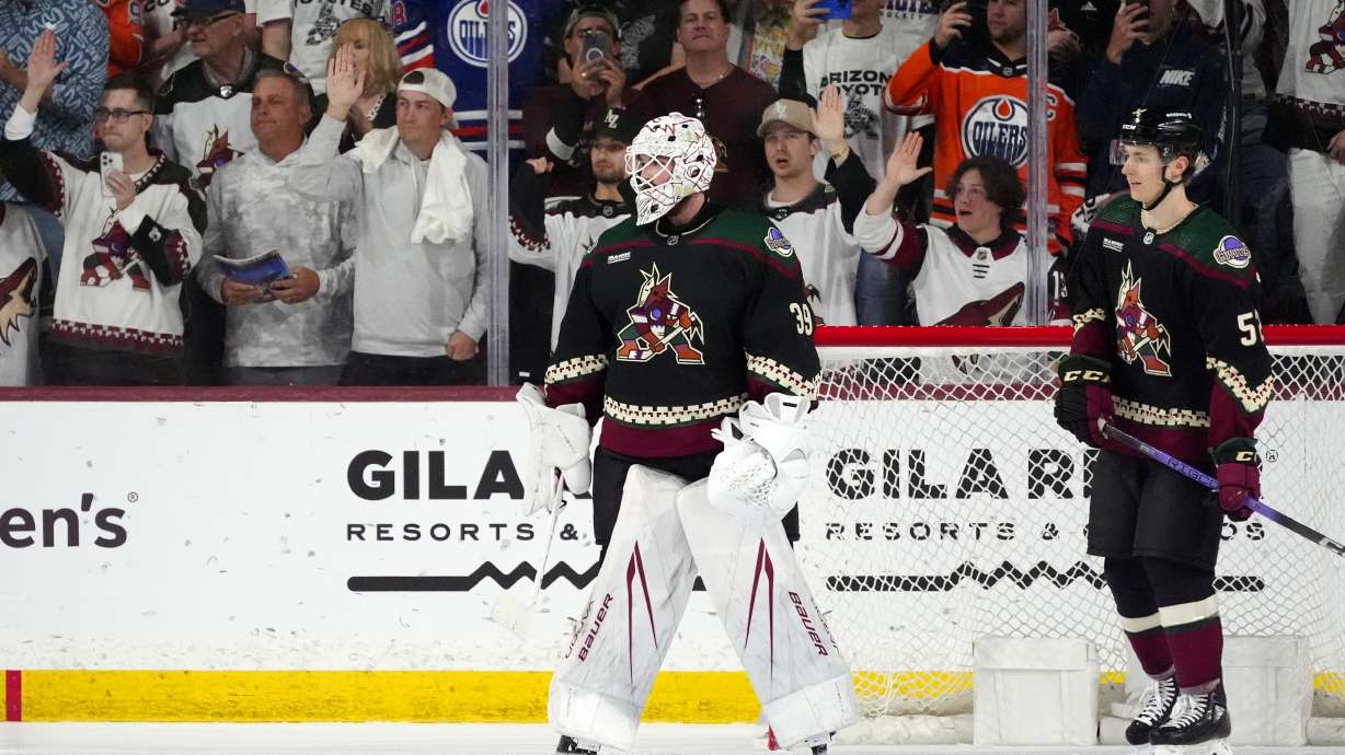 Arizona Coyotes goaltender Connor Ingram (39) and defenseman Vladislav Kolyachonok, right, watch the movement of the puck as time expires during the third period of the team's NHL hockey game against the Edmonton Oilers Wednesday, April 17, 2024, in Tempe, Ariz. The Coyotes won 5-2.