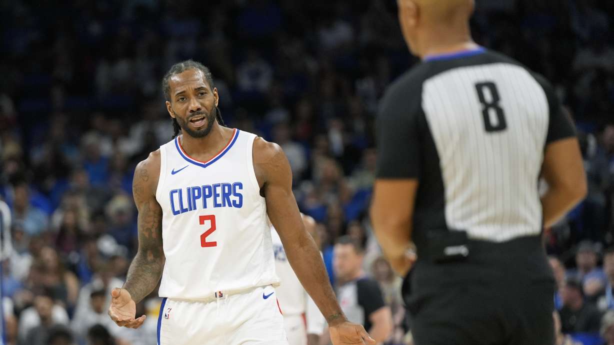 Los Angeles Clippers forward Kawhi Leonard (2) question a call by official Marc Davis (8) during the second half of an NBA basketball game against the Orlando Magic, Friday, March 29, 2024, in Orlando, Fla.