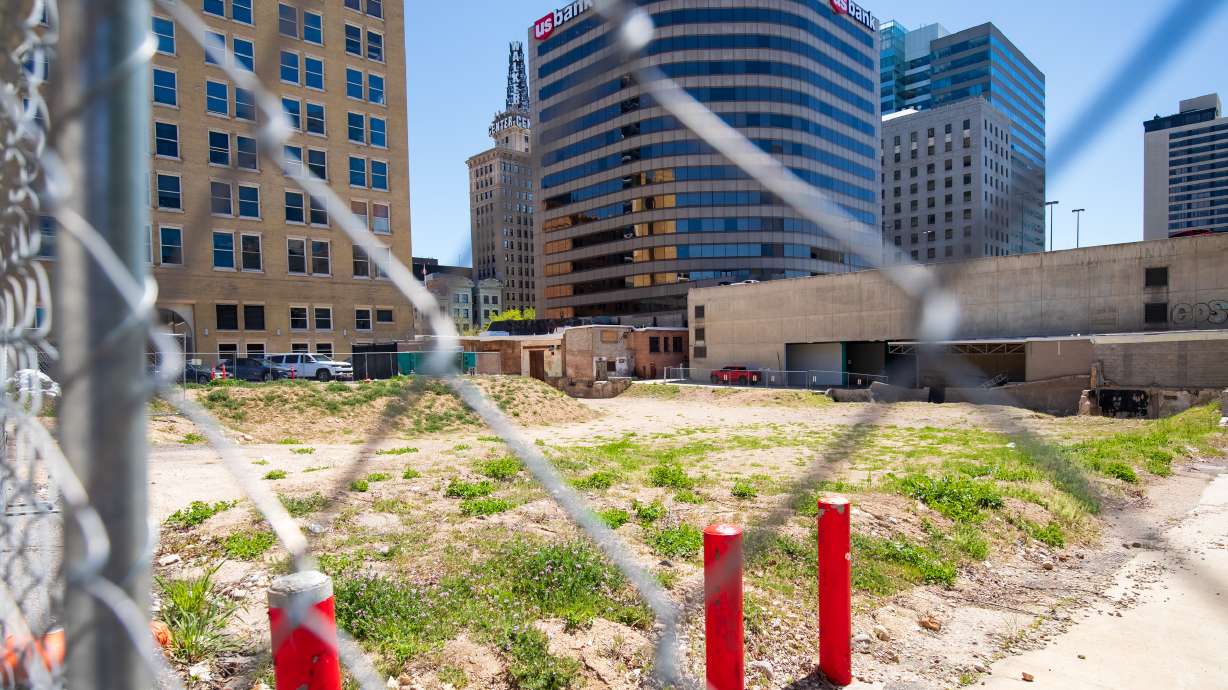 A fence blocks access to the lot where the Utah Pantages Theater once stood in downtown Salt Lake City on Thursday. The theater was torn down two years ago on Friday, but construction has yet to start a replacement.