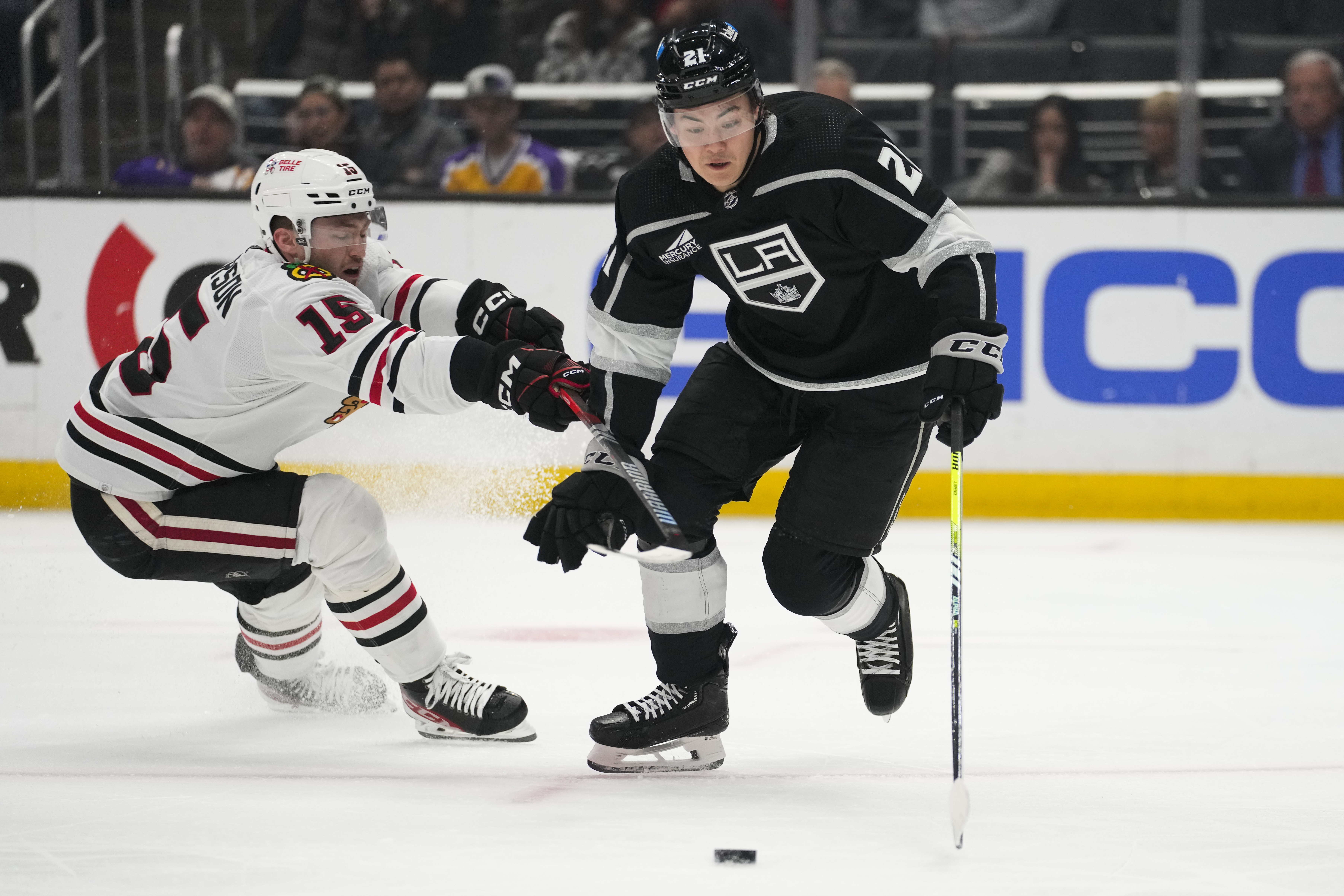 Chicago Blackhawks right wing Joey Anderson (15) defends against Los Angeles Kings defenseman Jordan Spence (21) during the first period of an NHL hockey game Thursday, April 18, 2024, in Los Angeles.