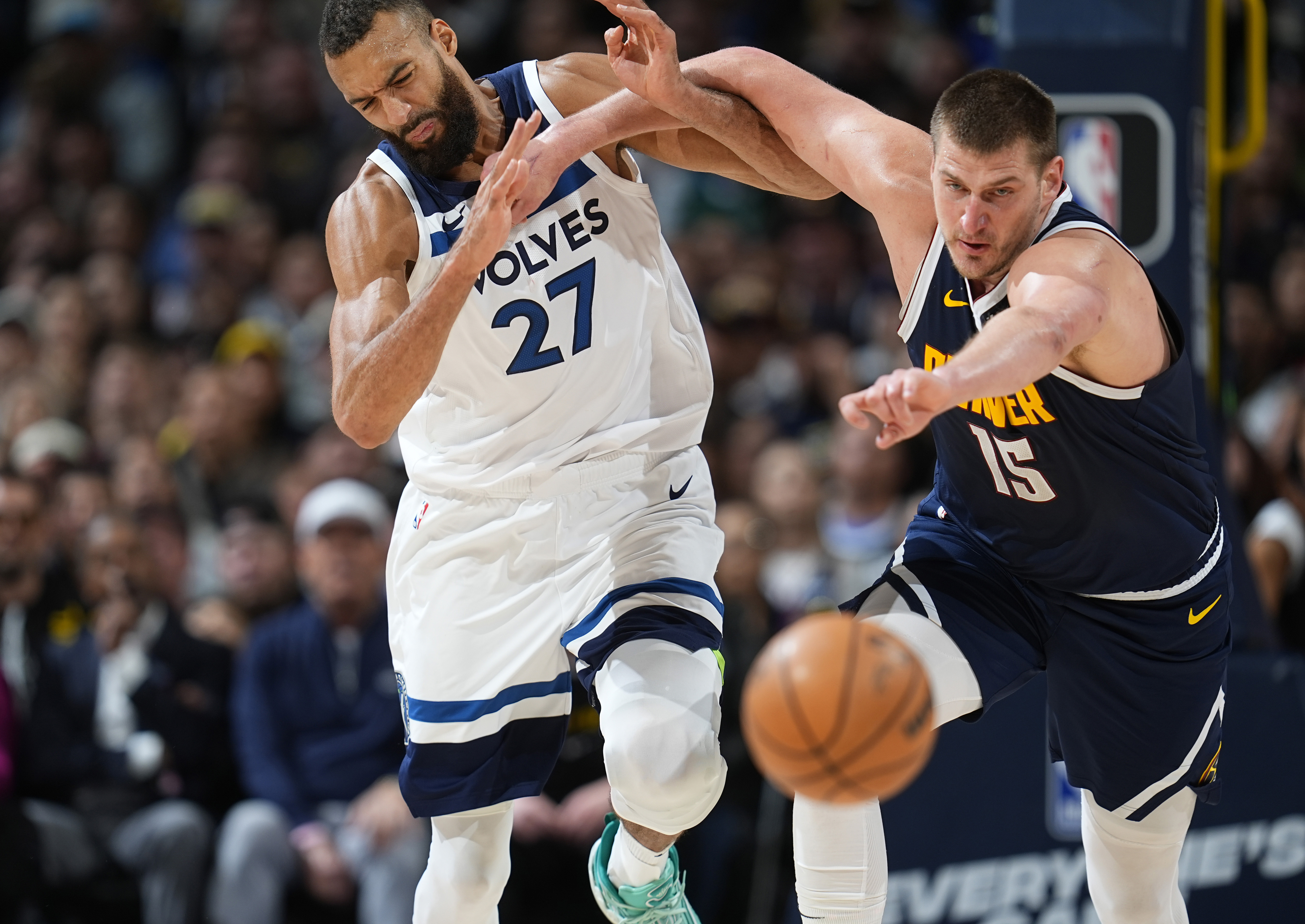 Denver Nuggets center Nikola Jokic, right, pushes Minnesota Timberwolves center Rudy Gobert while they pursue the ball during the second half of an NBA basketball game Wednesday, April 10, 2024, in Denver.