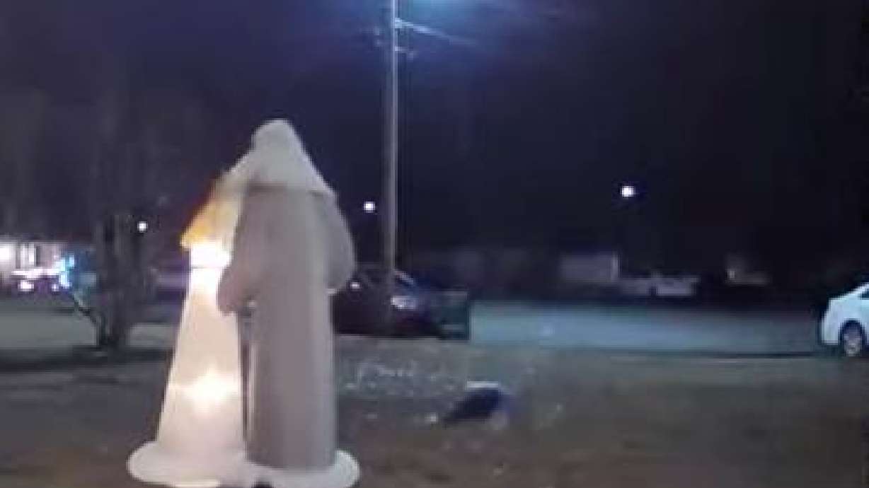A woman (on the ground) falls victim to an extension cord in the yard at a home, as seen in this doorbell camera footage captured Dec. 31, 2023.