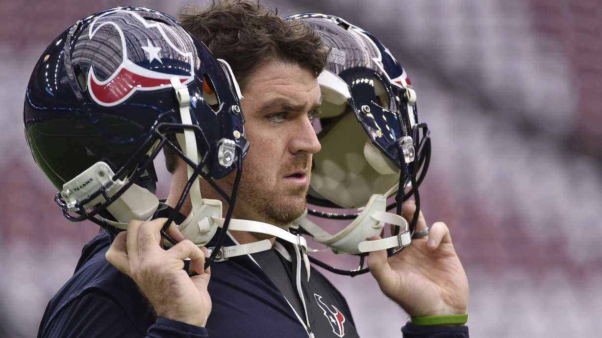 FILE - A Houston Texans staff member tests the helmet radio system before the first half of an AFC Wild Card NFL game between the Houston Texans and the Oakland Raiders, Saturday, Jan. 7, 2017, in Houston. Following a sign-stealing scandal that rocked the sport and hung over Michigan's championship run in 2023, the NCAA's football oversight committee approved Friday, April 19, 2024, the use of coach-to-player helmet communications in games for the 2024 season. The football rules committee last month made a recommendation to allow — but not require — teams at the highest tier of Division I to use radio technology similar to what NFL teams use.