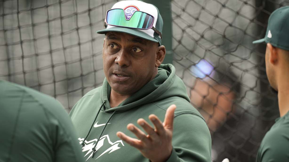 Colorado Rockies hitting coach Hensley Meulens chats with players before a baseball game against the Philadelphia Phillies on May 13, 2023, in Denver. Federal aviation officials said on Friday that they are investigating a video that appears to show Meulens sitting in the cockpit of a plane while it was in flight.