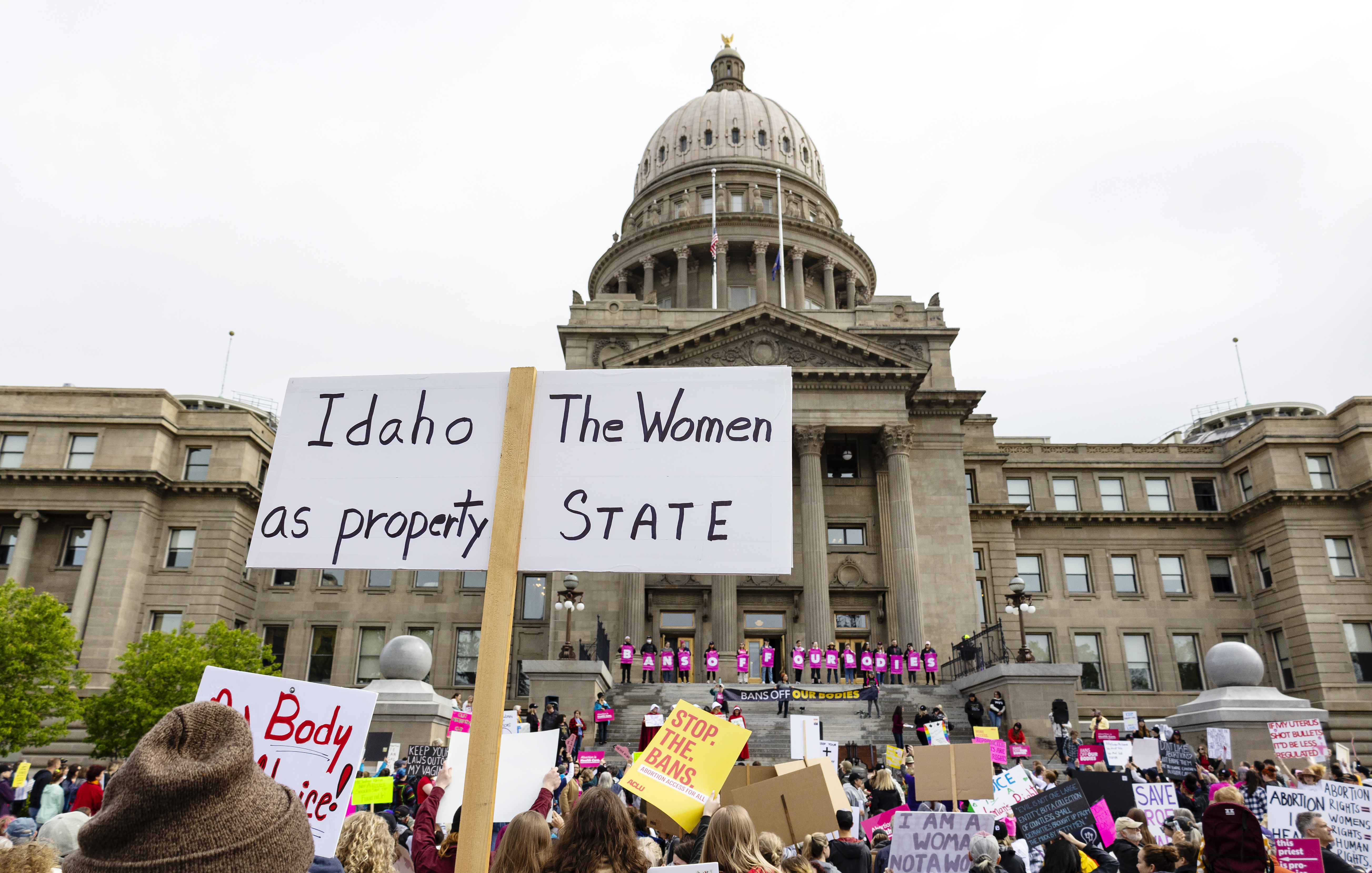 An attendee at Planned Parenthood's Bans Off Our Bodies rally for abortion rights holds a sign reading "Idaho the women as property state" outside of the Idaho Statehouse in downtown Boise, Idaho, on May 14, 2022.